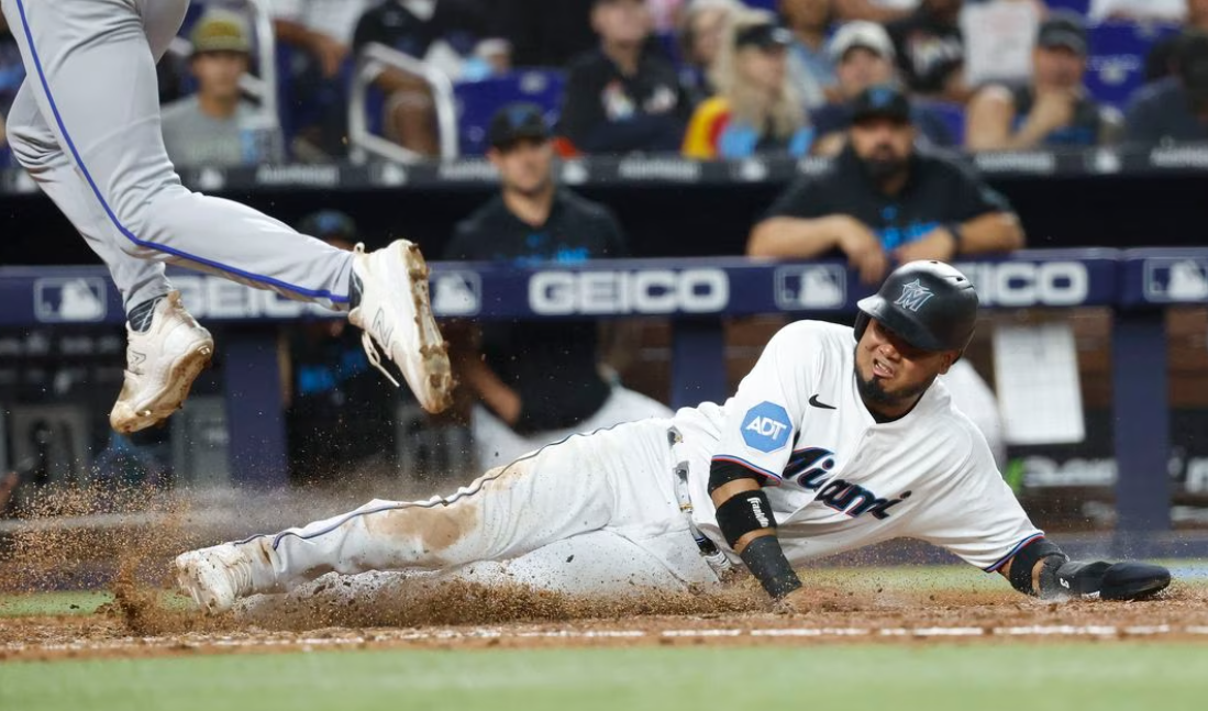 Miami Marlins second baseman Luis Arraez (3) scores on a wild pitch against the Kansas City Royals during the seventh inning at loanDepot Park in Miami, Florida, June 6, 2023.