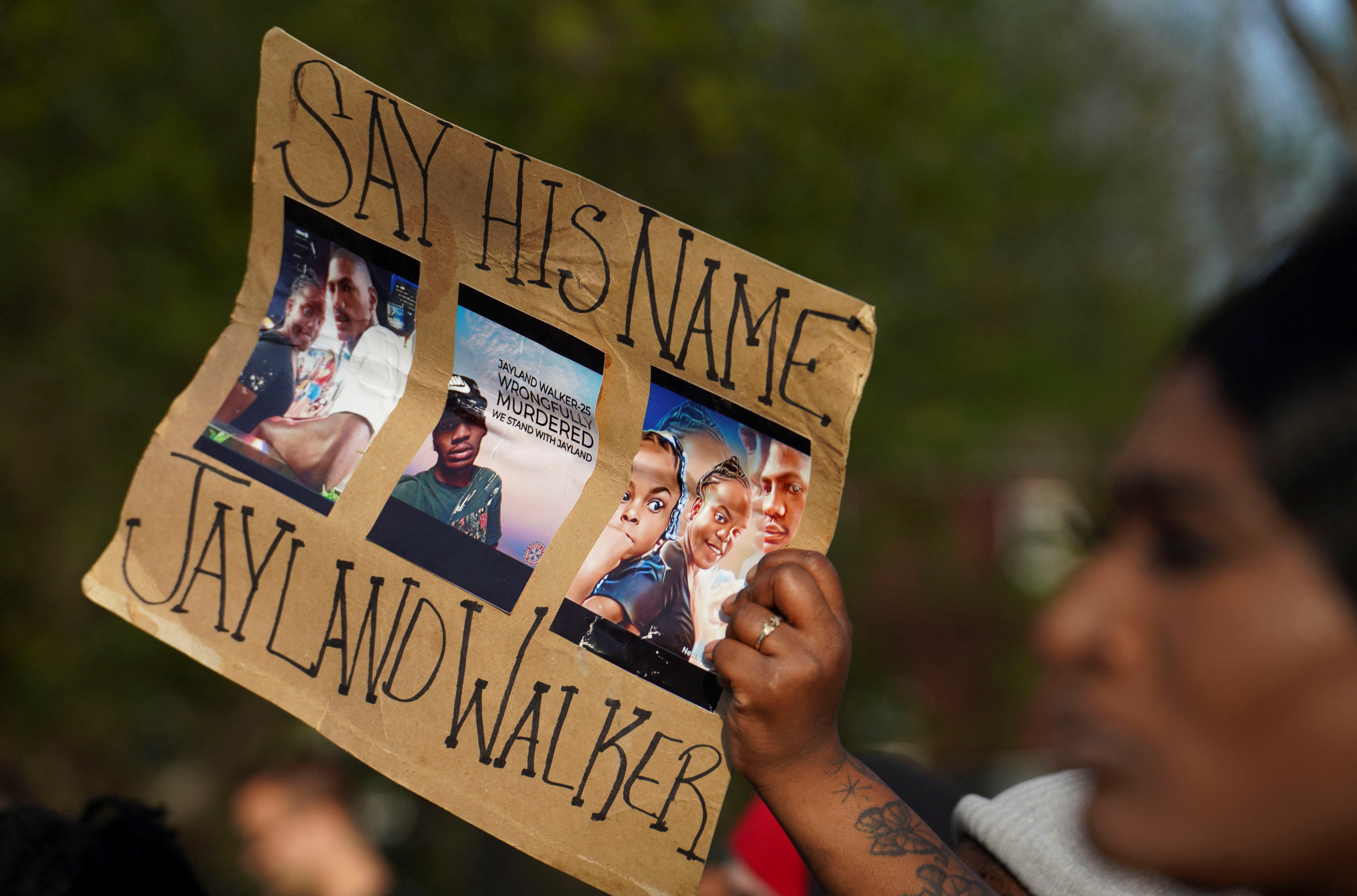 A demonstrator holds a placard during a protest held after a grand jury voted against indicting police officers in the fatal shooting of unarmed Black man Jayland Walker, in Akron, Ohio, U.S. April 19, 2023. REUTERS/Dieu-Nalio Chery/File Photo