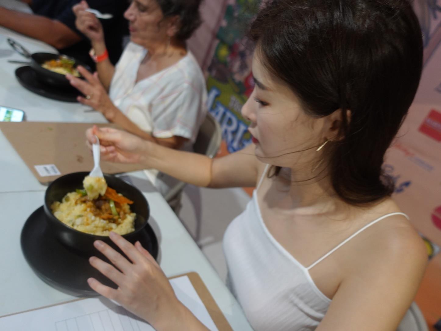 One of Korea’s top YouTube eaters, Fume, right, samples Chamorro bisteak in the 24th Annual Taste of the Marianas International Food Festival & Beer Garden on June 24, 2023, at Garapan Fishing Base in Saipan.  At left is Hotel Association of the Northern Mariana Islands legal counsel Marcia Schultz.
