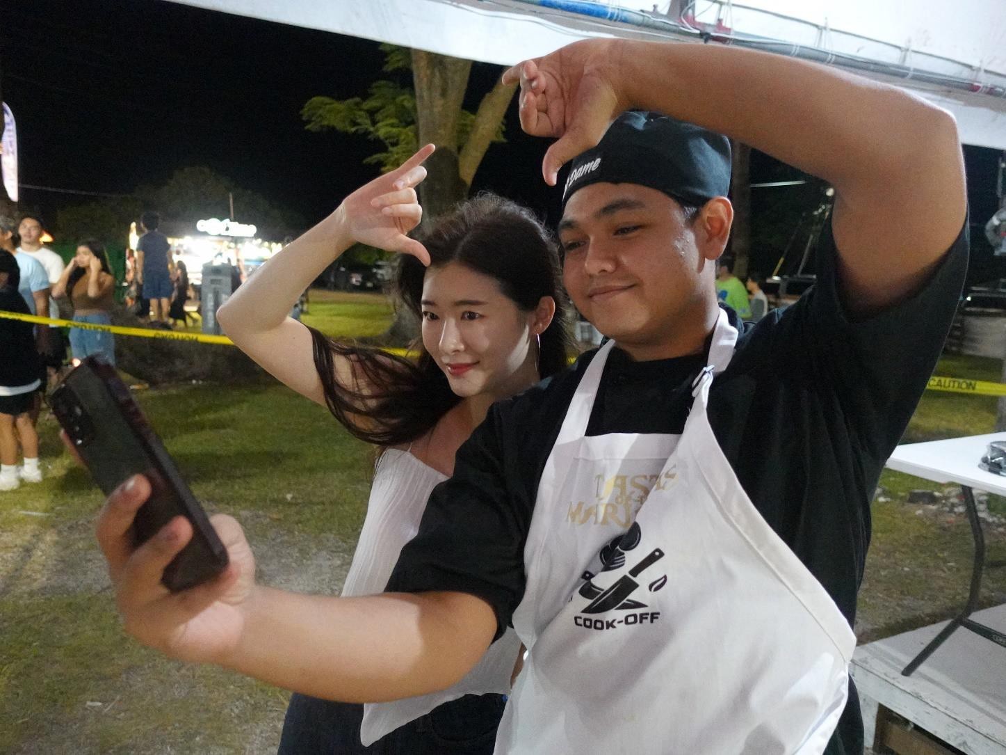 One of Korea’s top YouTube eaters, Fume, left, poses with 1st place winner Damian Palacios of the HANMI/NMTech Chamorro Bisteak Cookoff held at the 24th Annual Taste of the Marianas International Food Festival & Beer Garden on June 24, 2023, at Garapan Fishing Base in Saipan.  Fume was visiting the Marianas as part of a familiarization tour organized by the Marianas Visitors Authority to promote the destination.