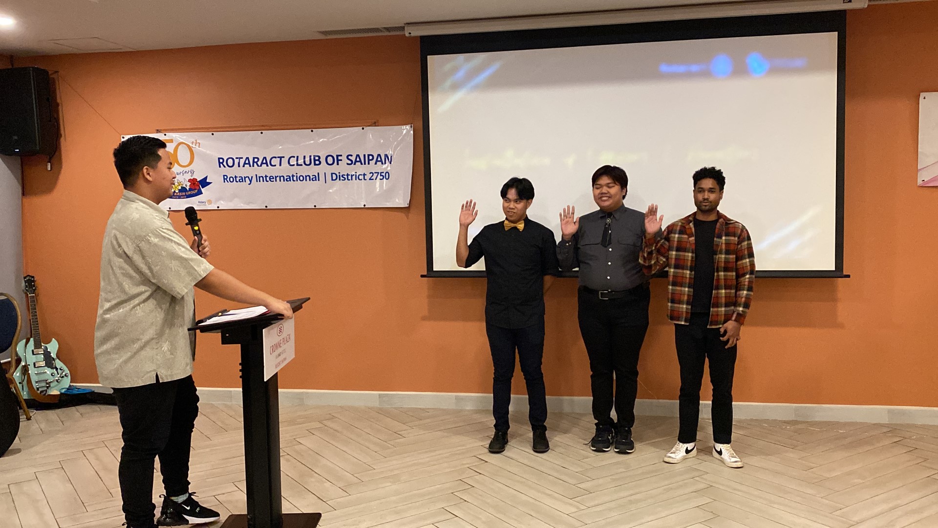 From left, Rotaract President Richard Baleares inducts new members Matthew Manuel, Gio Sagana, and Kayjon Boadi.