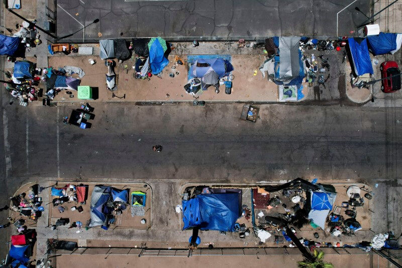 General view of a homeless encampment in downtown Phoenix as unhoused people receive medical care from Circle The City's mobile medical unit on the 14th day of temperatures rising to 110 degrees Fahrenheit, in Phoenix, Arizona, U.S., July 13, 2023. REUTERS/Liliana Salgado/File Photo