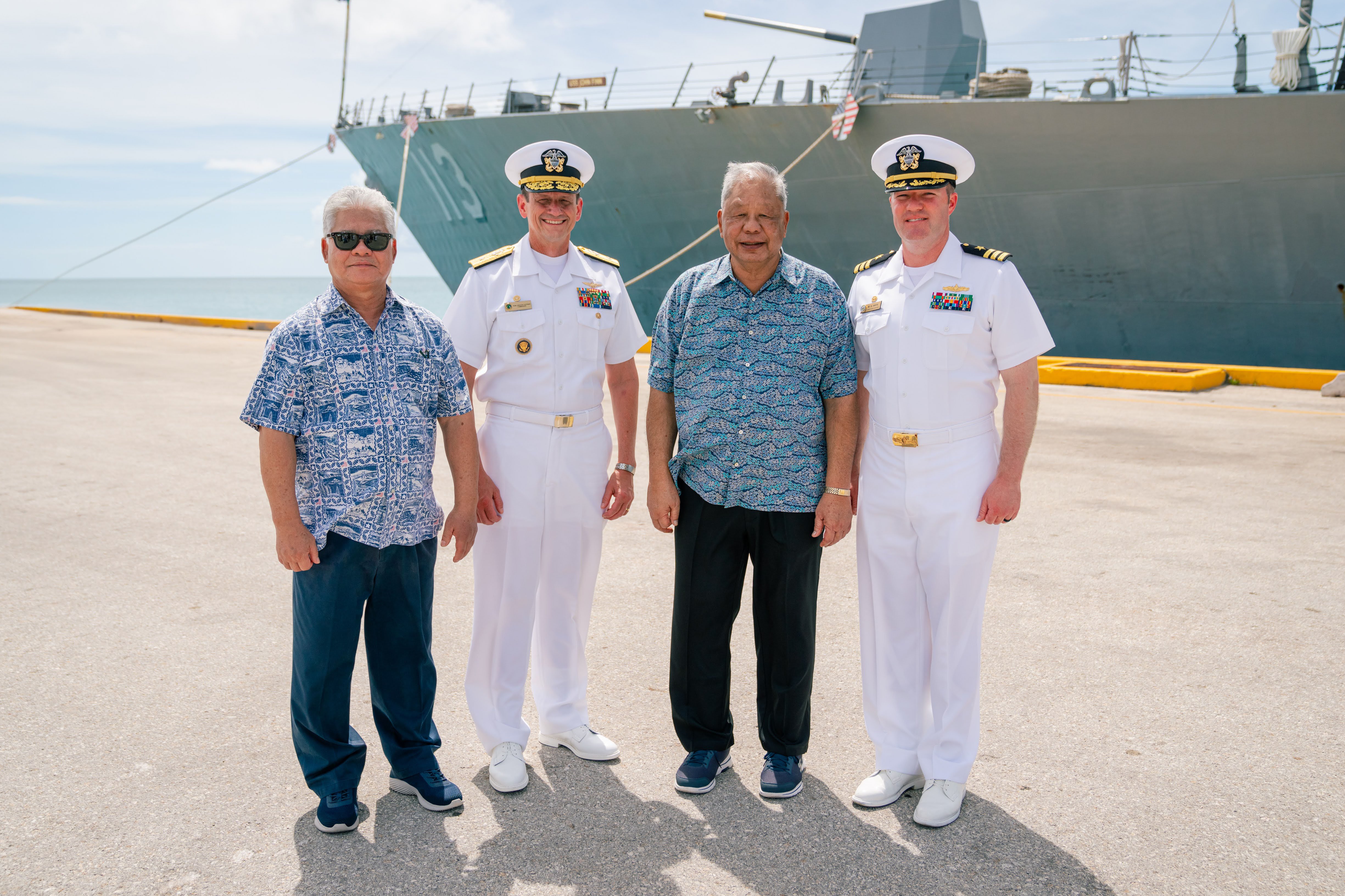 Gov.  Arnold I. Palacios, left,  and Lt. Gov. David M. Apatang, 2nd right, pose for a photo with Joint Region Marianas Commander Rear Adm. Gregory C. Huffman and USS John Finn Commanding Officer Matthew Hays on Monday afternoon at the Saipan port. The USS John Finn, a guided missile destroyer  is on island for a scheduled port call. Its senior officers will participate in the CNMI’s Liberation Day festivities today, Tuesday.