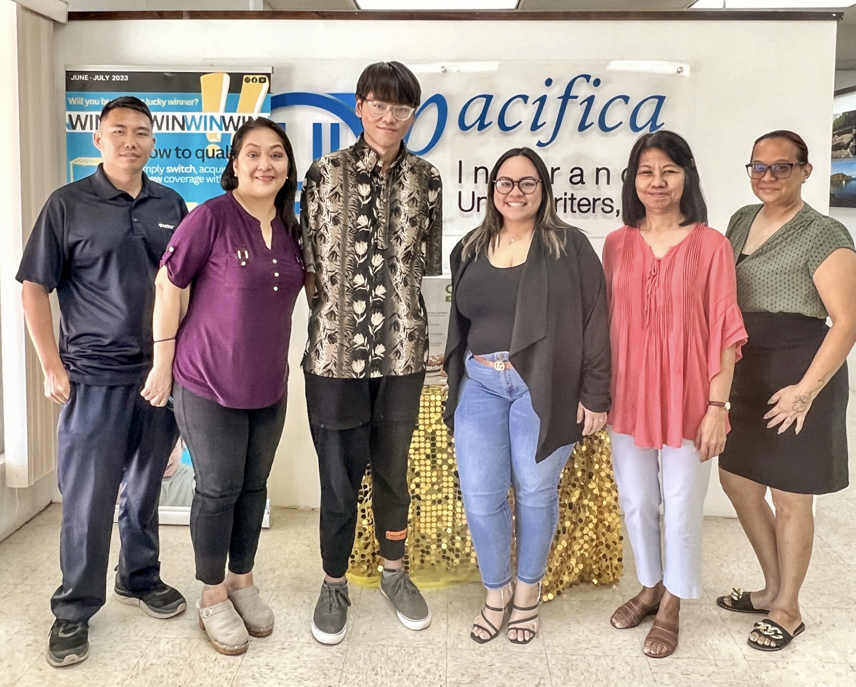 One of the student-interns at Pacific Insurance Underwriters Inc., Jhaylin Cruz, 16, third left, poses with company employees Jessica Sablan, Tess Gella, Dionne Camacho, Jane Madarang, and Tyler Yoshimoto.