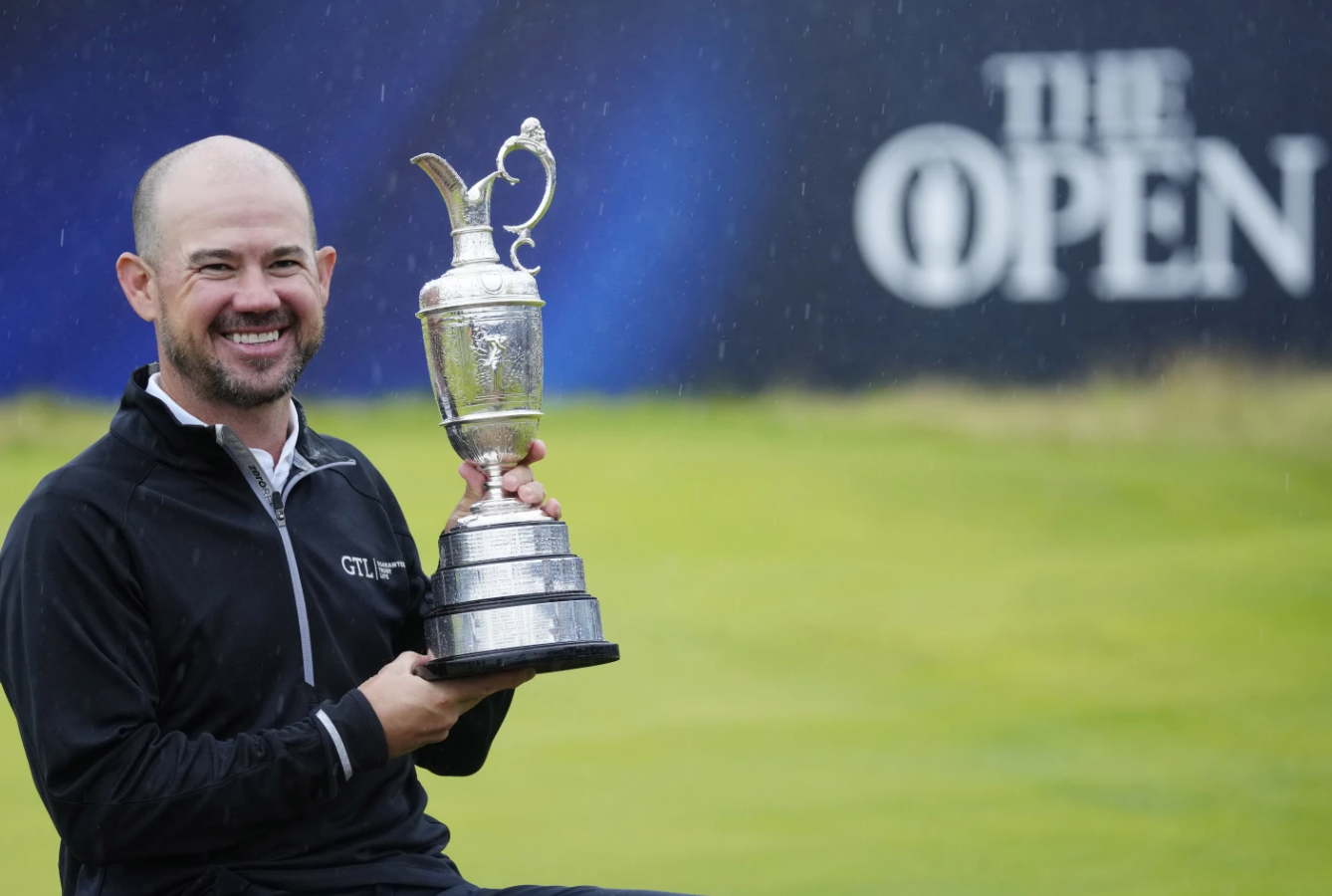 Brian Harman of the United States poses for the media as he holds the Claret Jug trophy for winning the British Open Golf Championships at the Royal Liverpool Golf Club in Hoylake, England, Sunday, July 23, 2023.