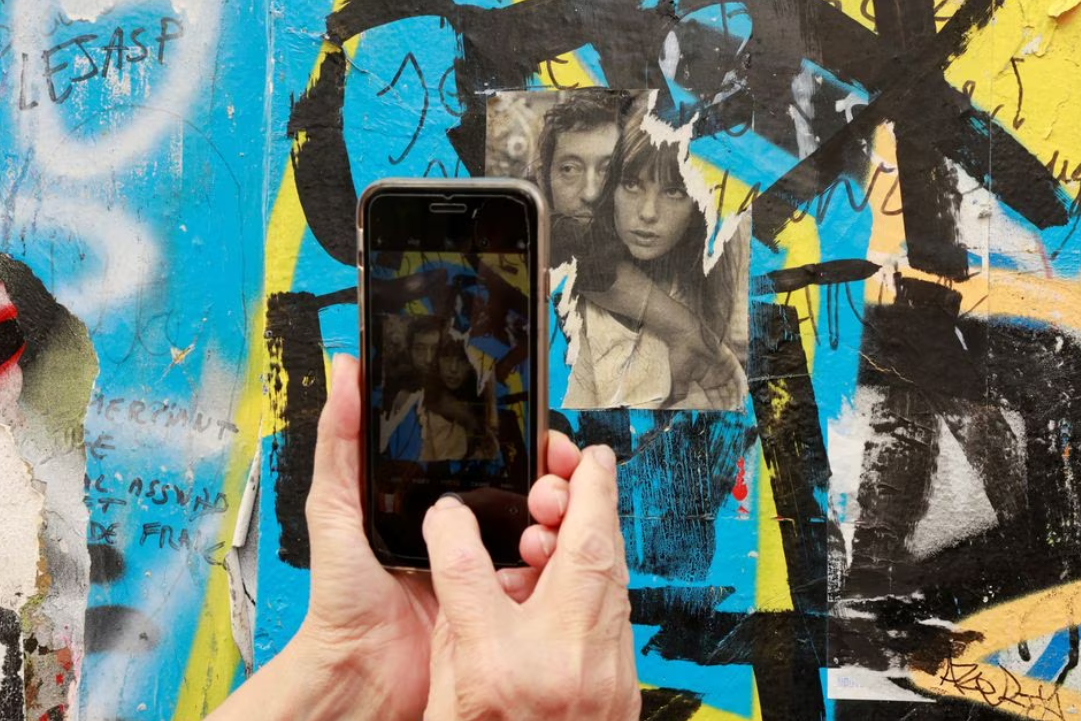 A person takes a photo near the house turned museum where Jane Birkin has lived with Serge Gainsbourg, in Paris, France, July 16, 2023.