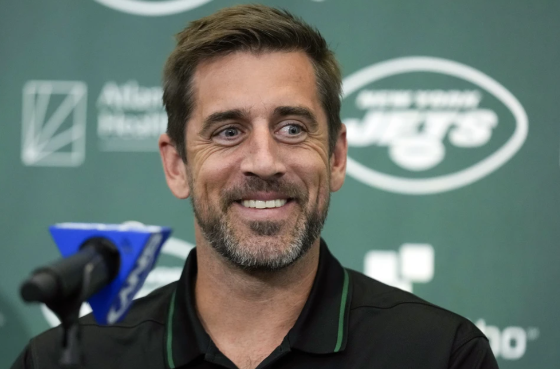 New York Jets quarterback Aaron Rodgers smiles during an NFL football news conference at the Jets' training facility in Florham Park, N.J., April 26, 2023.