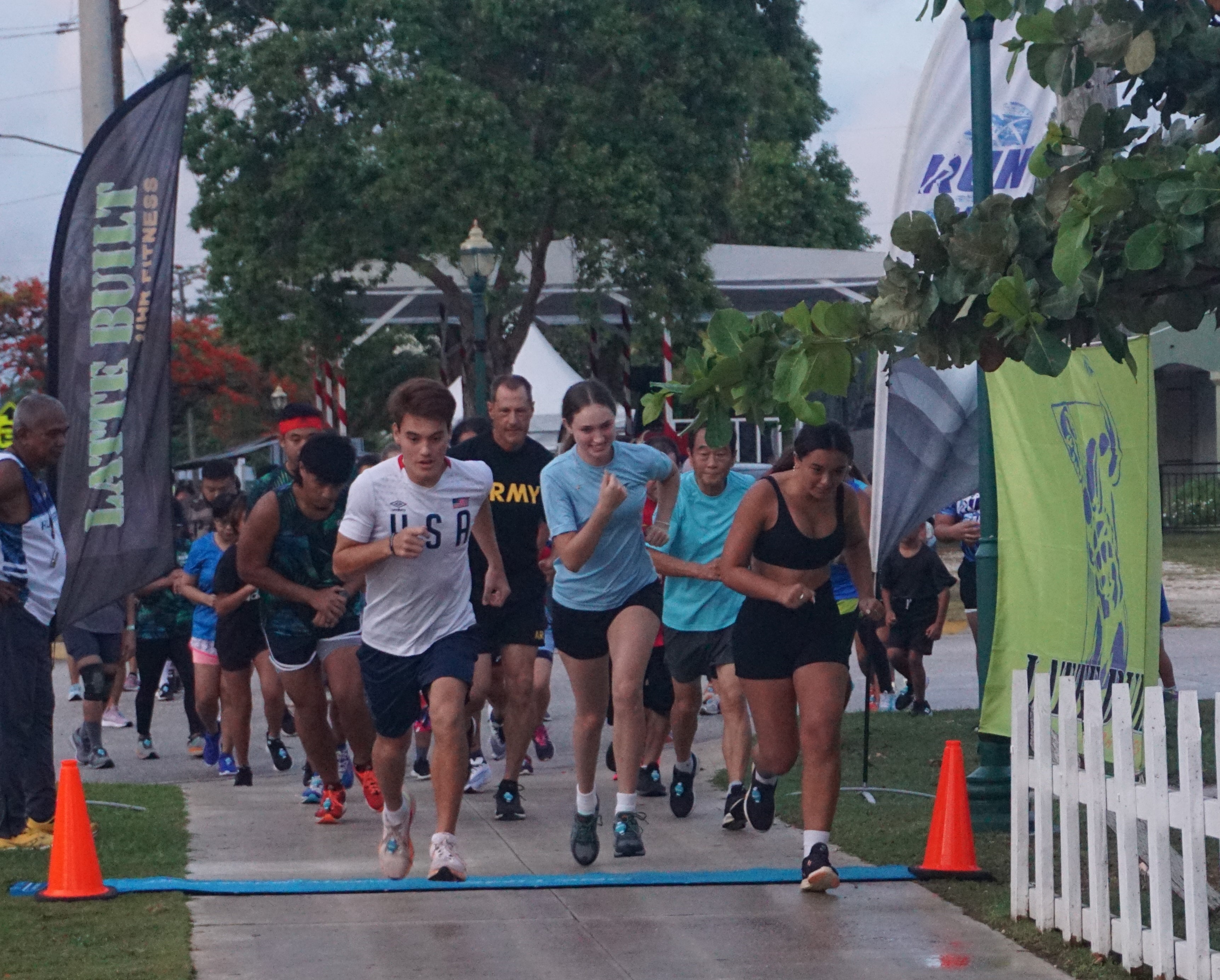 Participants take off at the start of the 3rd Annual 4th of July Independence Day 2-Mile Run on Tuesday morning at the Garapan Fishing Base.