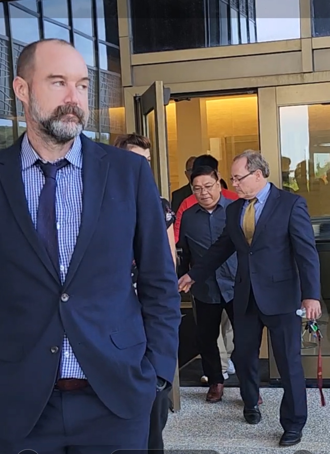 Bonifacio “Boni” Sagana walks out of the federal courthouse with his defense team after jurors found him guilty Wednesday afternoon.
