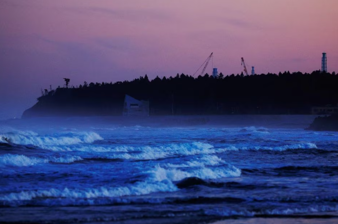 Ventilation stacks and cranes at the disabled Fukushima Dai-ichi nuclear power plant are seen from a beach in Namie, about 7 km away from the power plant, in Fukushima Prefecture, Japan, Feb. 28, 2023.