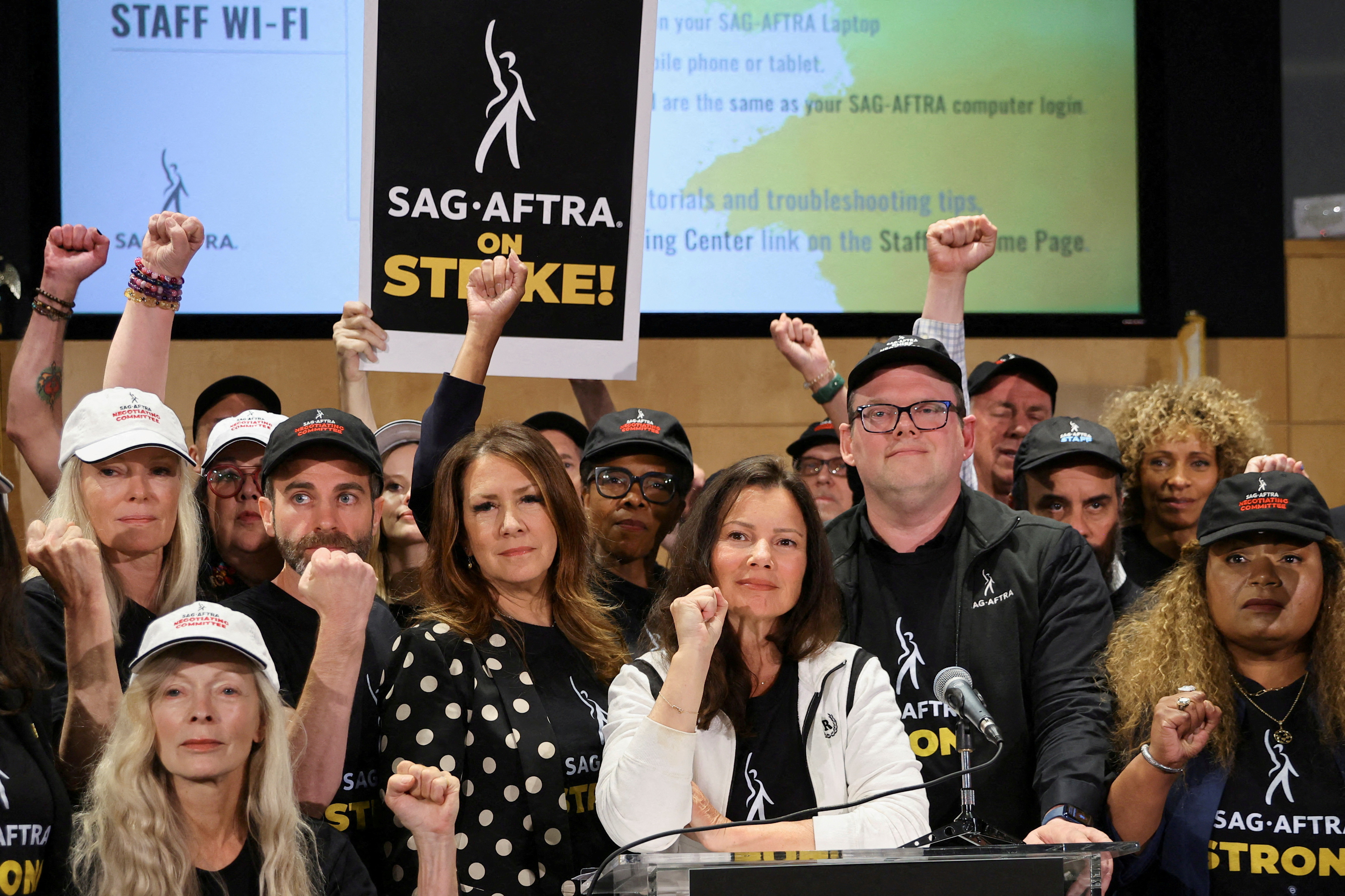 SAG-AFTRA union President Fran Drescher, Duncan Crabtree-Ireland, SAG-AFTRA National Executive Director and Chief Negotiator, and union members gesture at SAG-AFTRA offices after negotiations ended with the Alliance of Motion Picture and Television Producers (AMPTP), the entity that represents major studios and streamers, including Amazon, Apple, Disney, NBCUniversal, Netflix, Paramount, Sony, and Warner Bros Discovery, triggering an actors’ strike, in Los Angeles, California, U.S., July 13, 2023. REUTERS/Mike Blake
