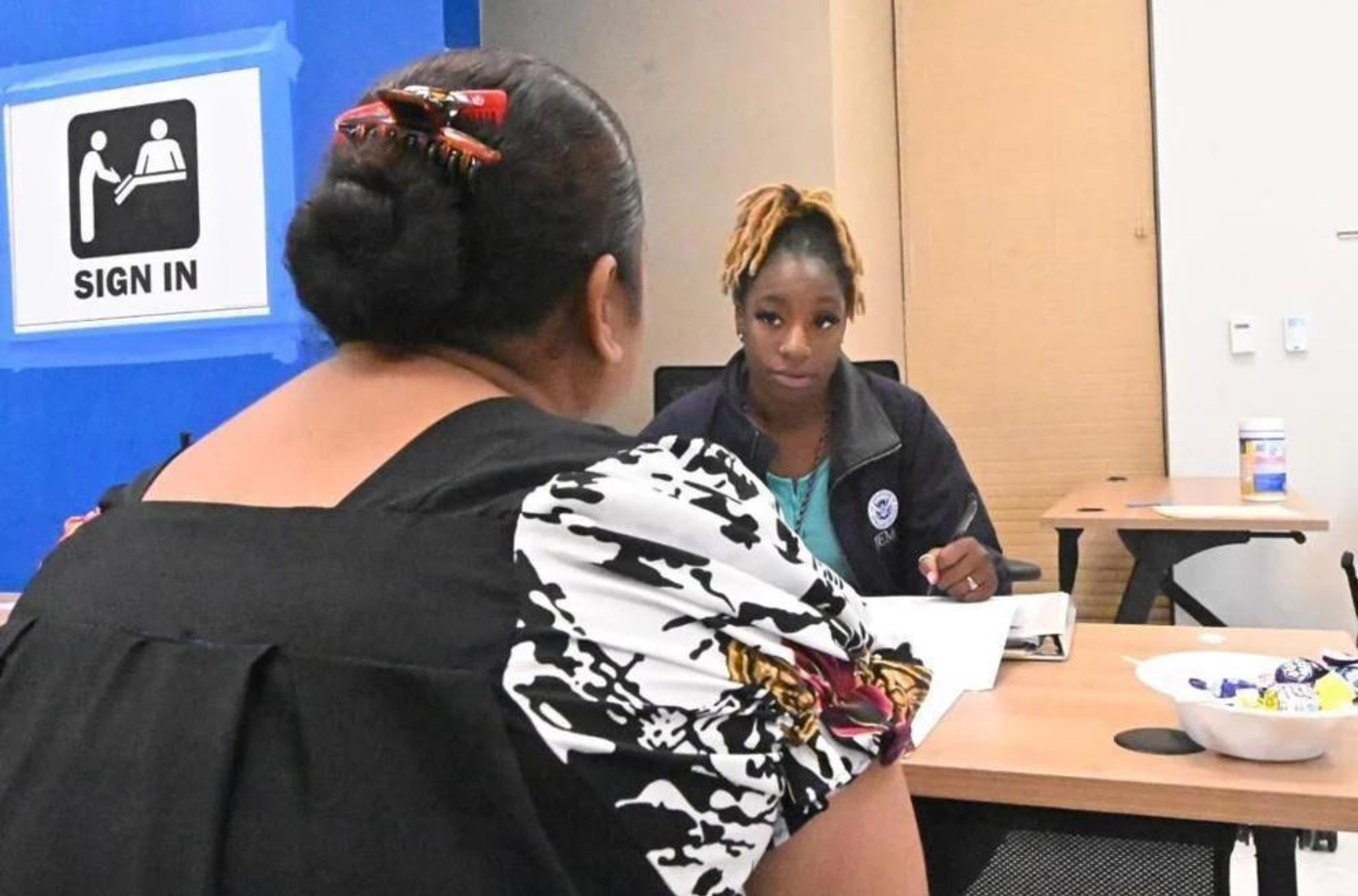 Grace McCraney, FEMA applicant service program specialist, helps a client apply for assistance at the FEMA Disaster Recovery Center June 18 at the GCC Campus in Mangilao. 