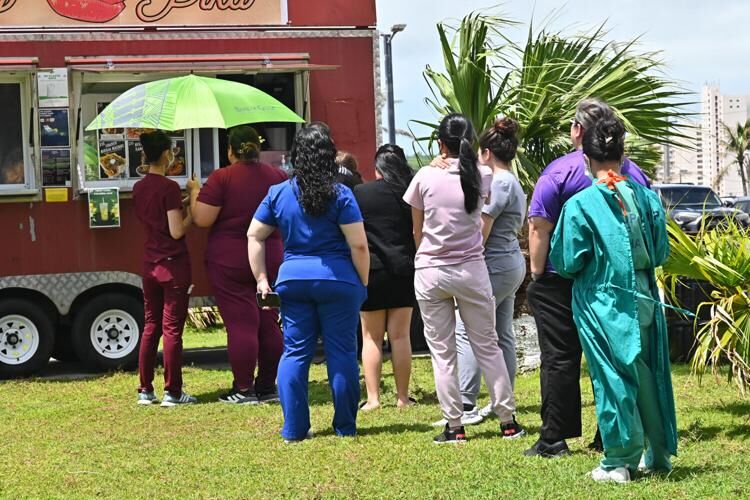 A long line of medical personnel wait to buy lunch Monday in front of Guam Memorial Hospital in Tamuning. David Castro/The Guam Daily Post
