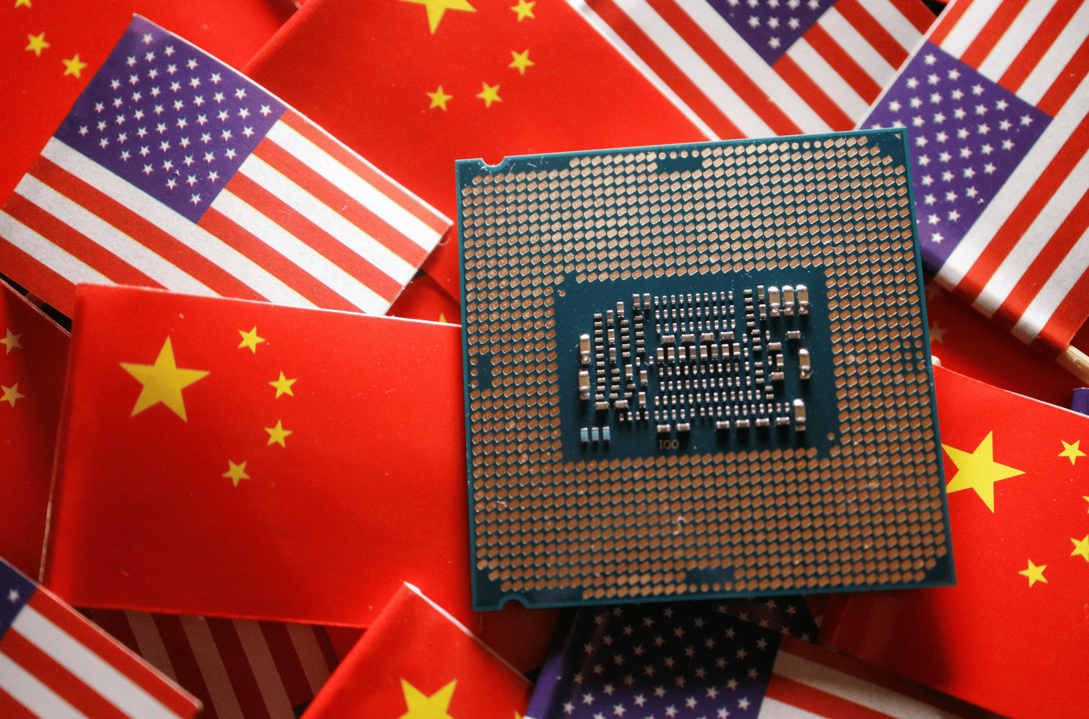 A central processing unit (CPU) semiconductor chip is displayed among flags of China and U.S., in this illustration picture taken February 17, 2023. REUTERS/Florence Lo/Illustration
