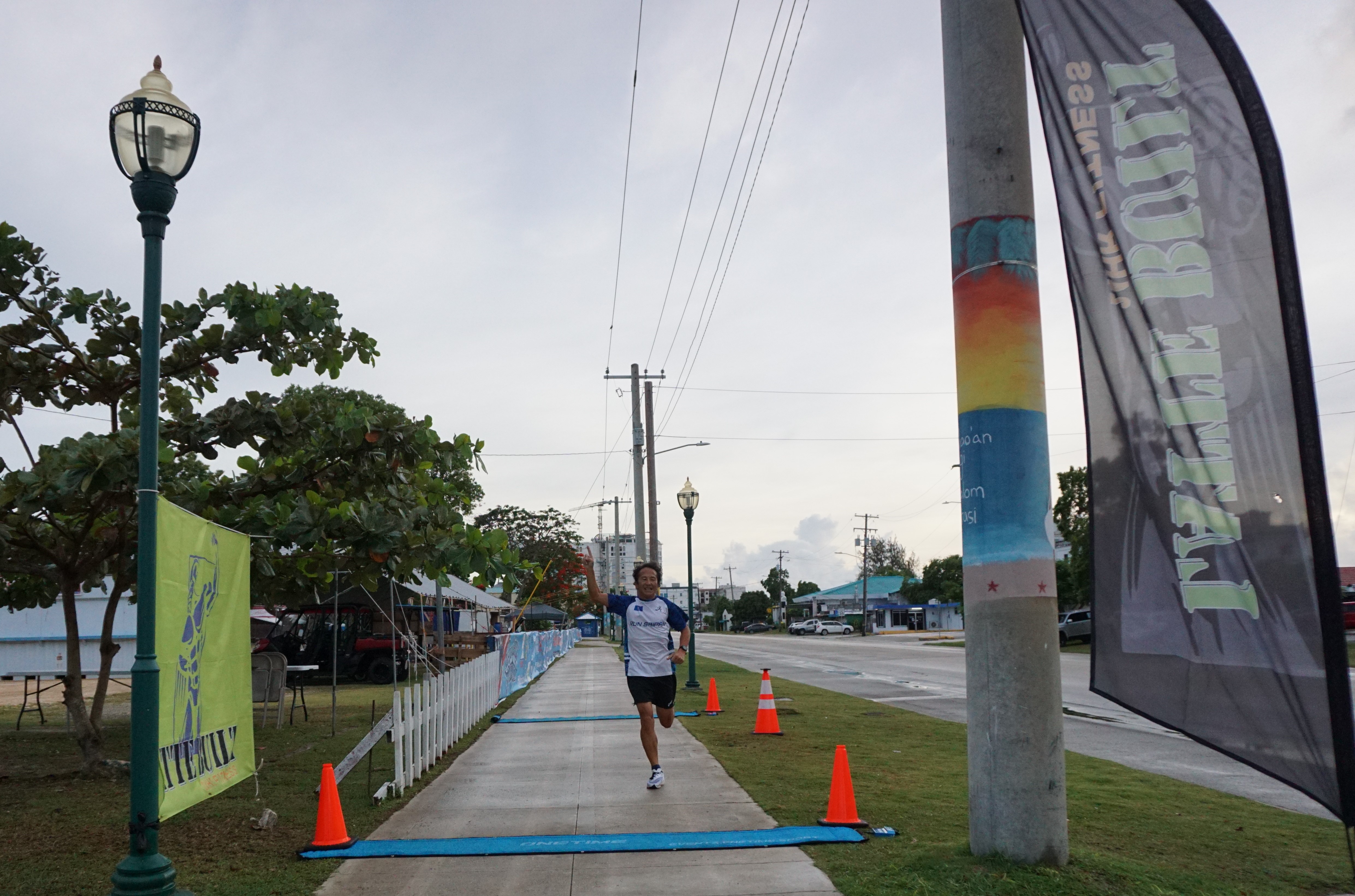 Kosuke Sato finishes first overall in the 3rd Annual 4th of July Independence Day 2-Mile Run on Tuesday morning at the Garapan Fishing Base.