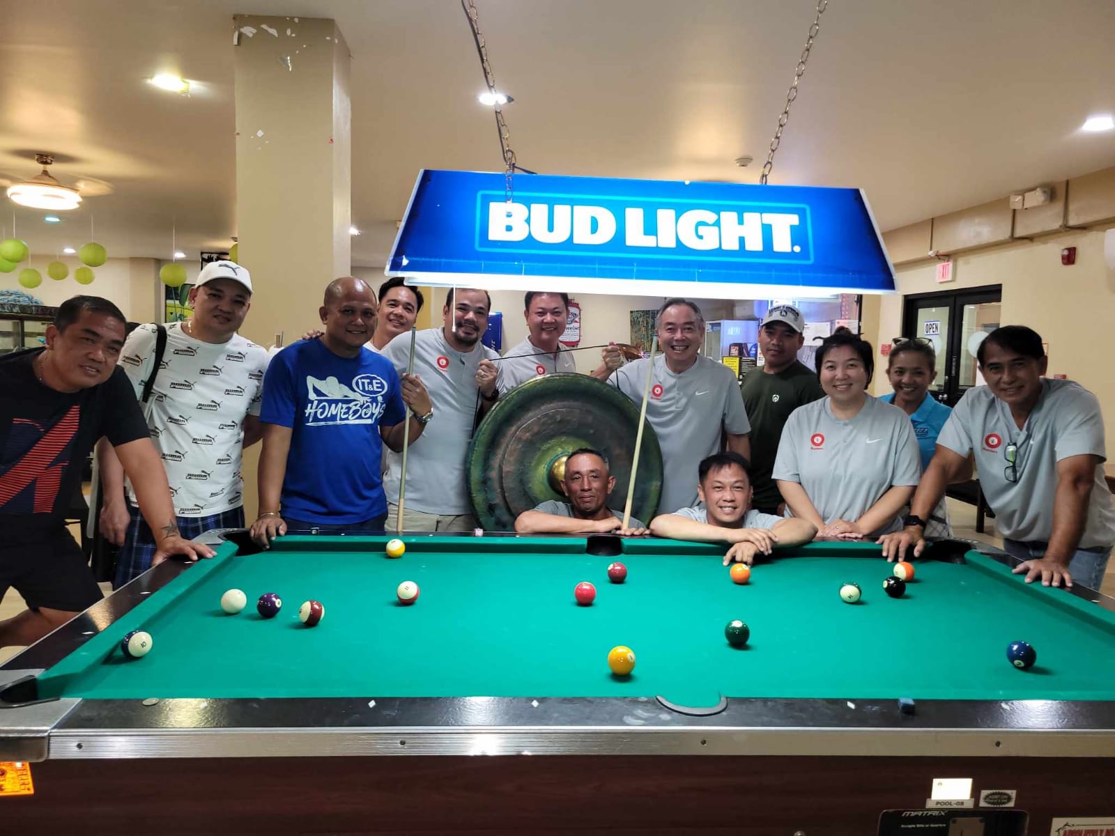 The Rendezvous IT&E Destroyers and the Black 8 Ideal Signs Rustlers pose for a photo at the conclusion of their Tuesday Division match in the 2023 SBA Budweiser Open 8-Ball League at  Rendezvous Restaurant, Saipan Vegas.