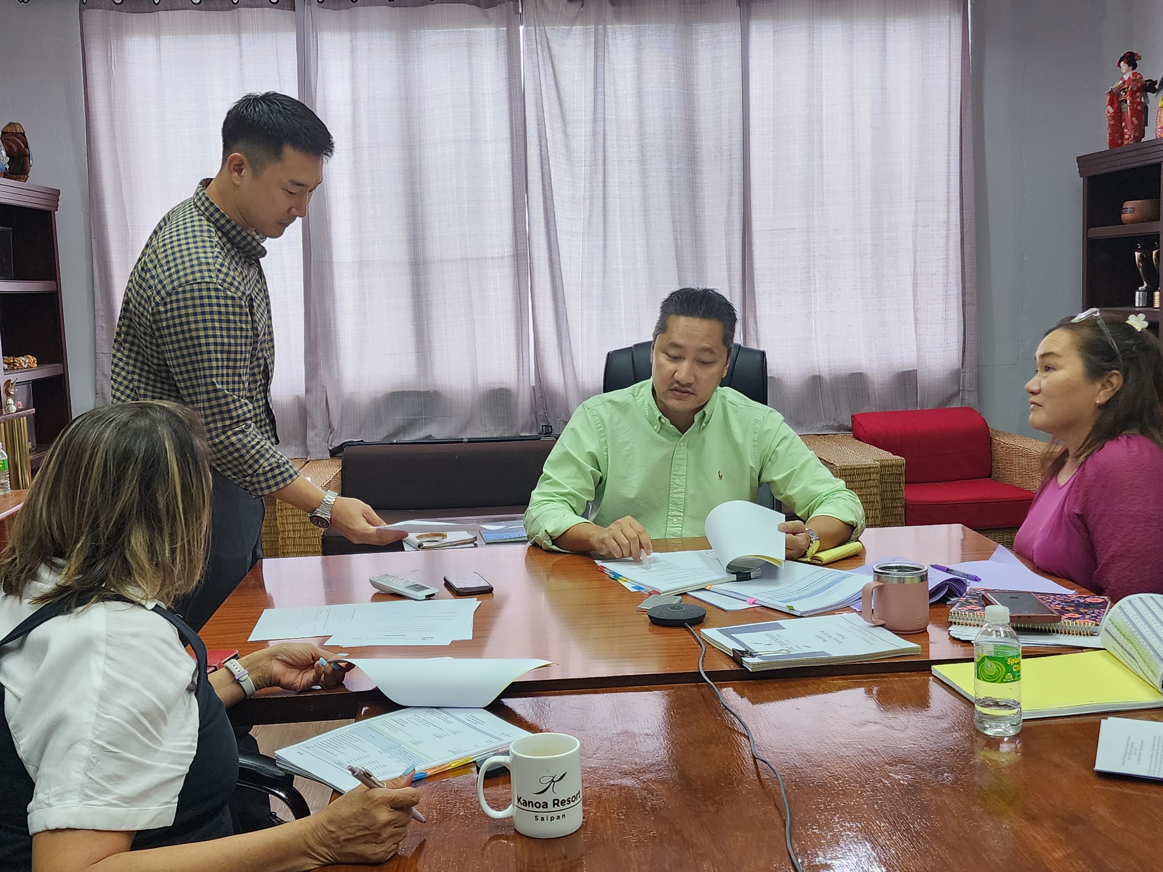 Marianas Visitors Authority Managing Director Christopher Concepcion, center, with MVA Marketing Manager Thomas Kim, left standing, MVA Deputy Managing Director Judy C. Torres, right, and MVA acting Chair Gloria Cavanagh, left, back to the camera. 
