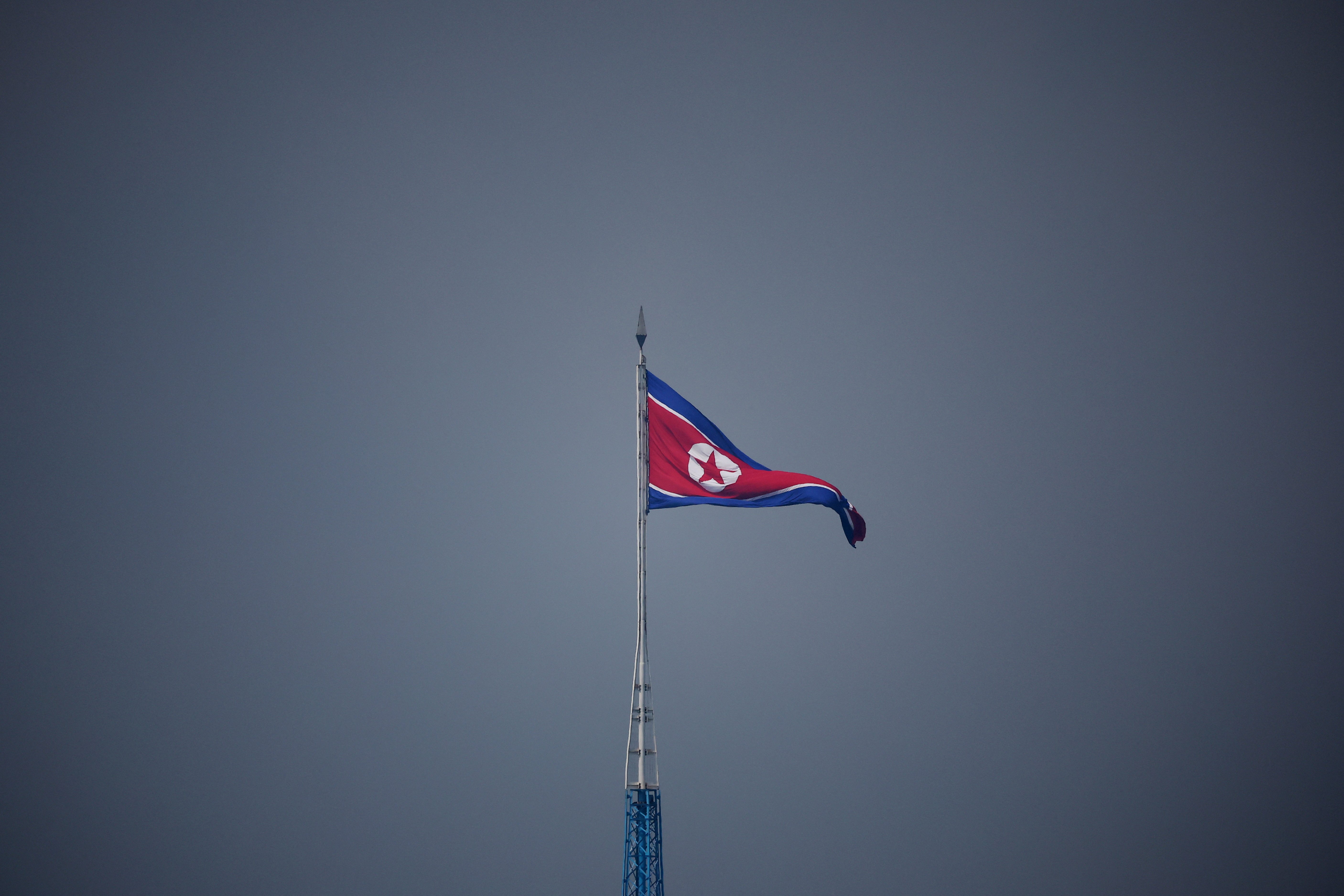 FILE PHOTO: A North Korean flag flutters at the propaganda village of Gijungdong in North Korea, in this picture taken near the truce village of Panmunjom inside the demilitarized zone (DMZ) separating the two Koreas, South Korea, July 19, 2022. REUTERS/Kim Hong-Ji/Pool/File Photo