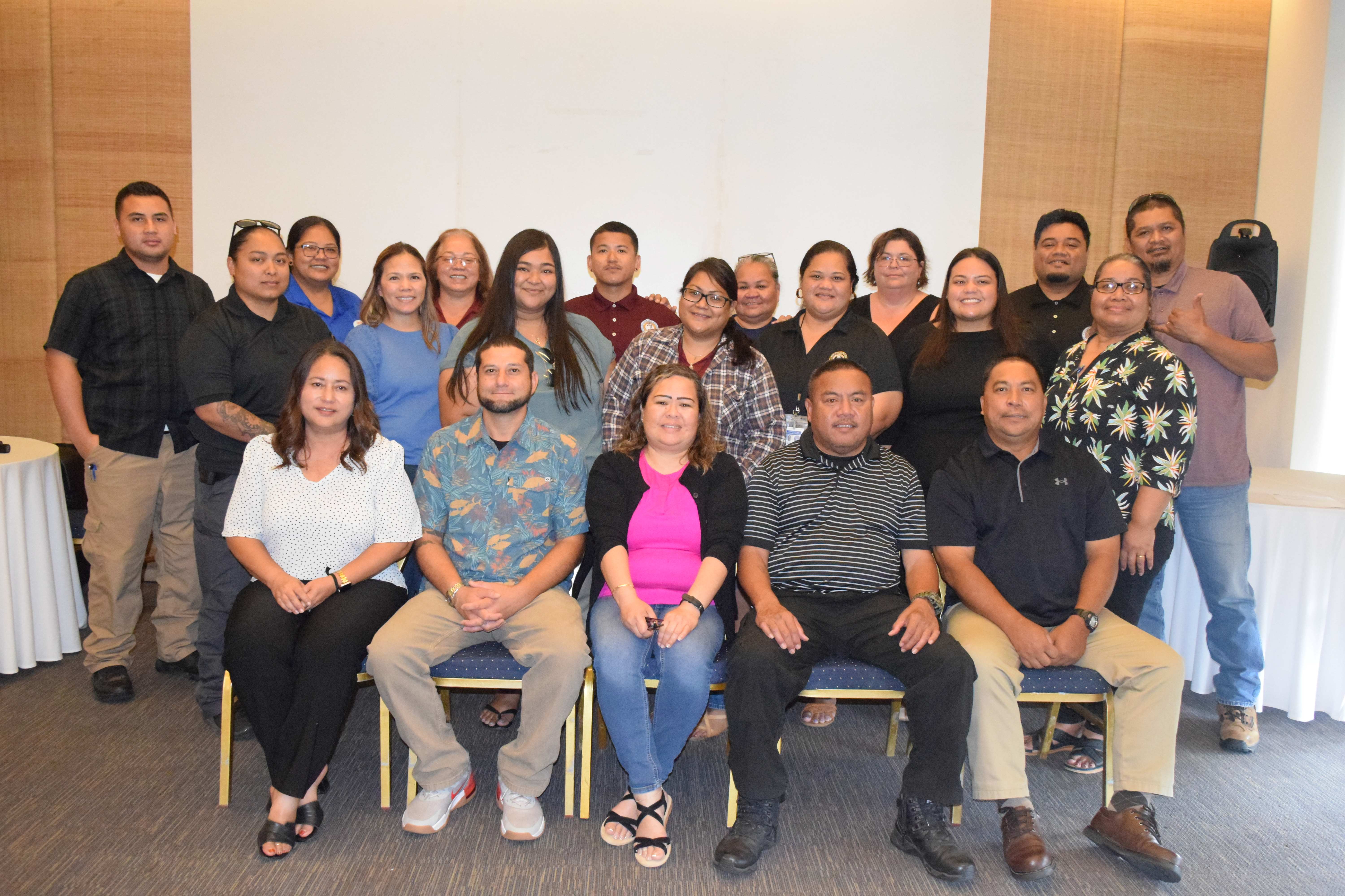 Division of Youth Services Administrator Vivian Sablan, center and representatives of the other agencies involved with the School Attendance Review Committee pose for a photo during a break from a workshop at LaoLao Bay Golf Resort  on Friday.