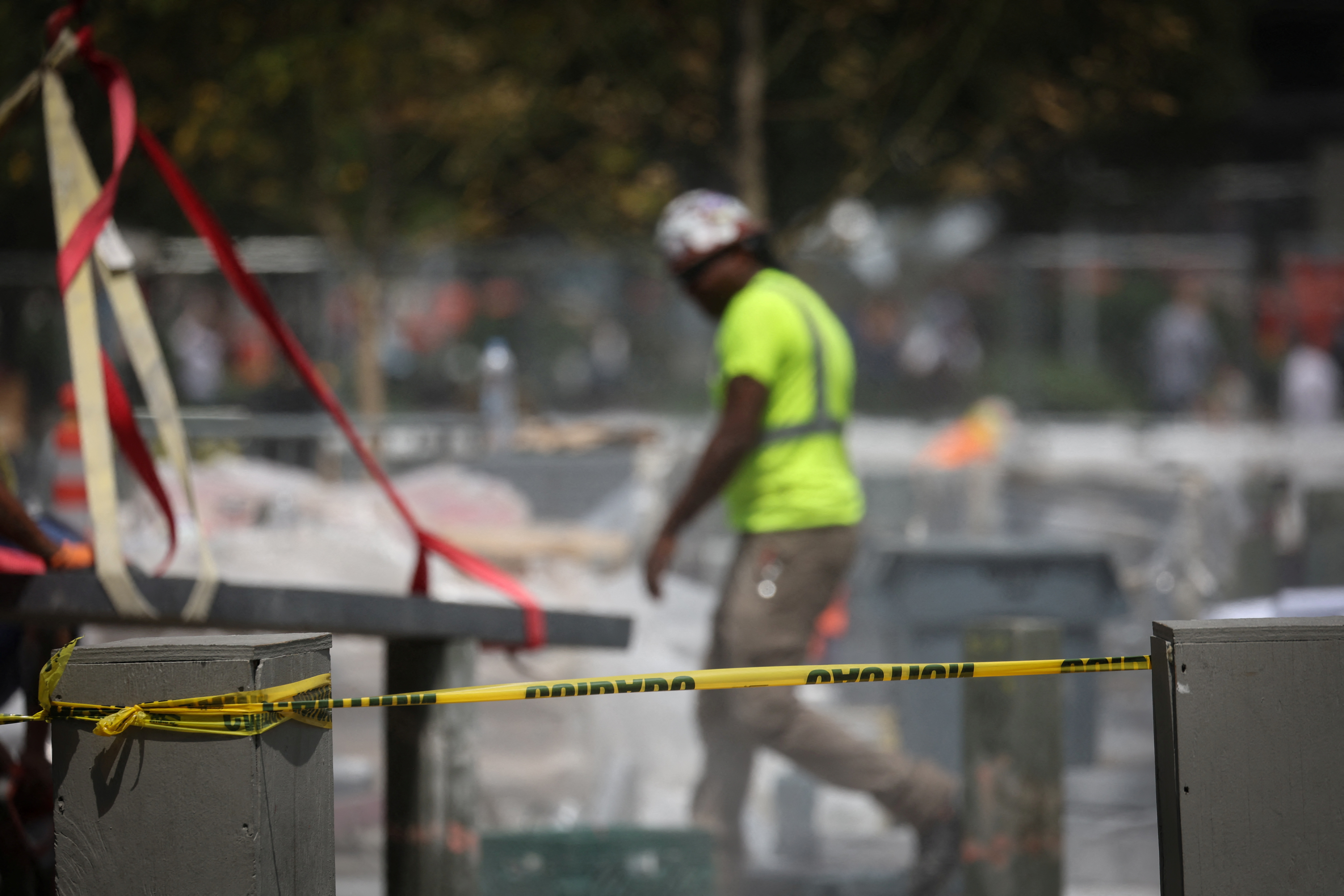 A worker from a road paving crew walks on a job site, after New York City issued an excessive heat warning, during hot weather in lower Manhattan in New York City, New York, U.S., July 27, 2023. REUTERS/Mike Segar