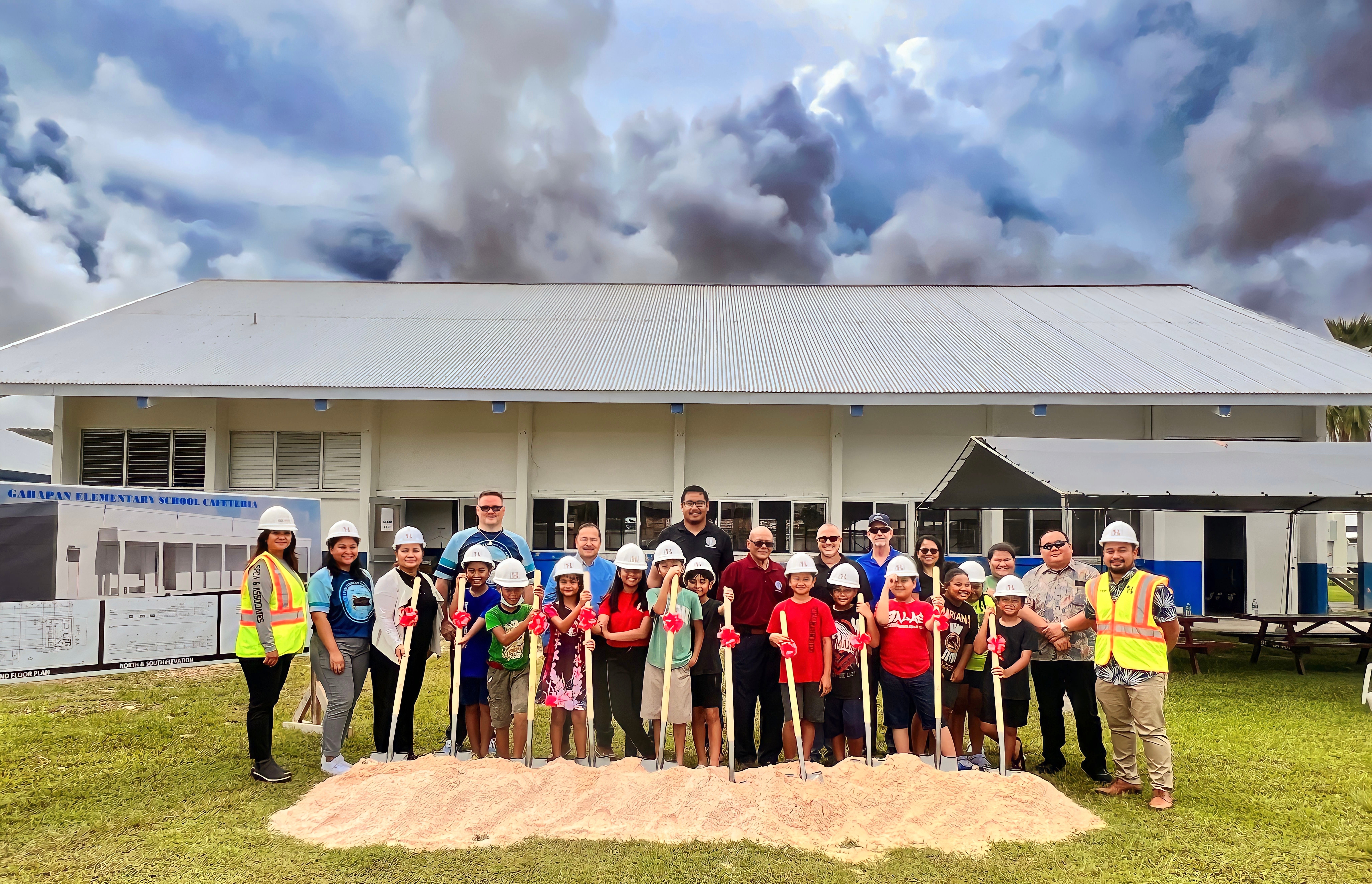 Garapan Elementary School students join education and HBR officials in a groundbreaking ceremony for a new school cafeteria on Tuesday. In photo are Board of Education Chairman Antonio L. Borja, Vice Chairman Herman Atalig, Secretary/Treasurer Gregory Pat Borja, Member Maisie B. Tenorio, Commissioner of Education Dr. Alfred B. Ada, Associate Commissioner for Administrative Services Eric Magofna, PSS-Child Nutrition Program Director Dale Roberts, PSS-Facilities Development and Management Interim Director Martha Kintol, GES Principal Derwin Johnson, GES Vice Principal Jacklyn Quitugua, HBR International Managing Director John Saludez, and HBR Construction Manager Sonya P. Dancoe, PE. 