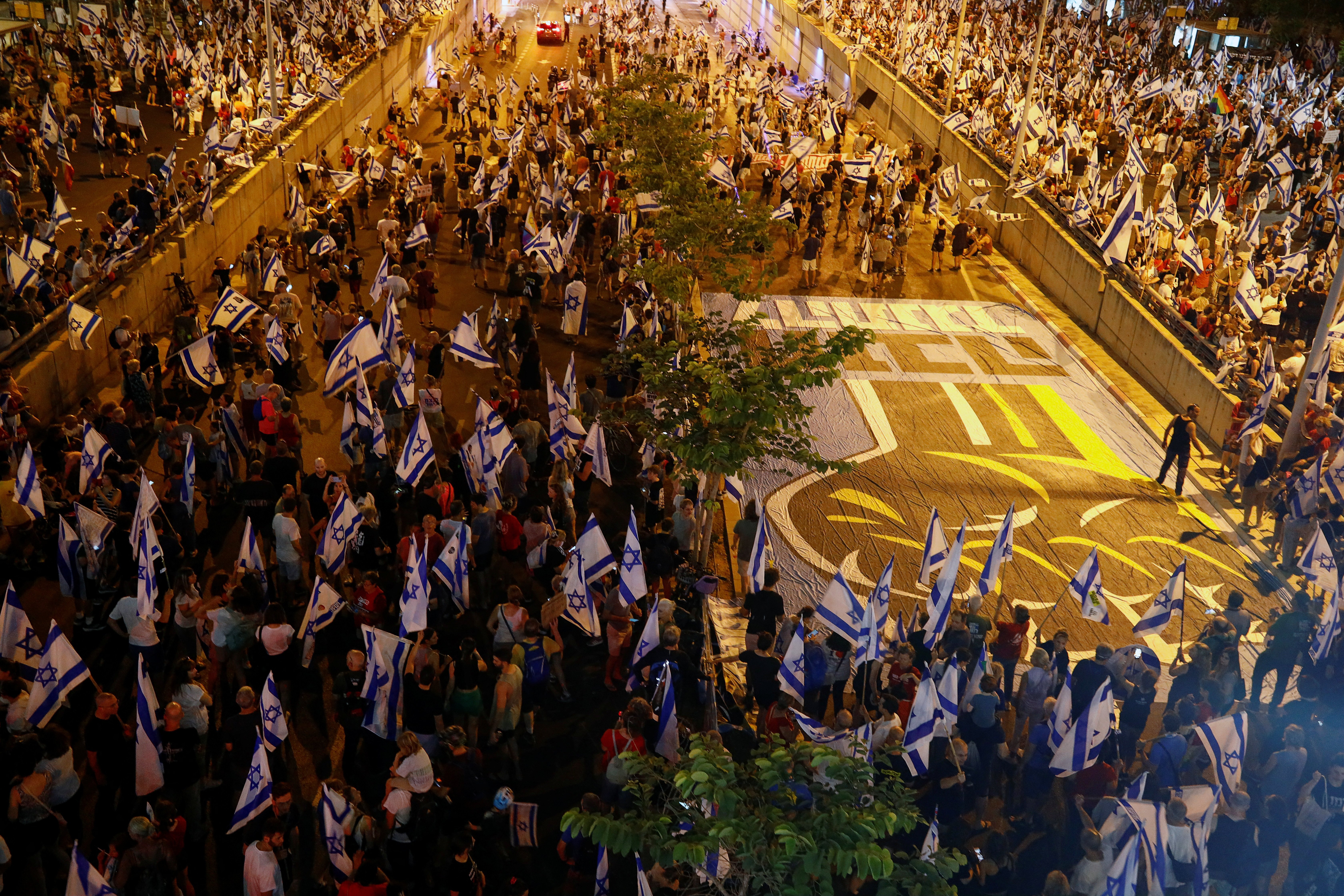 People take part in a demonstration against Israeli Prime Minister Benjamin Netanyahu and his nationalist coalition government's judicial overhaul, in Tel Aviv, Israel, July 22, 2023. REUTERS/Corinna Kern