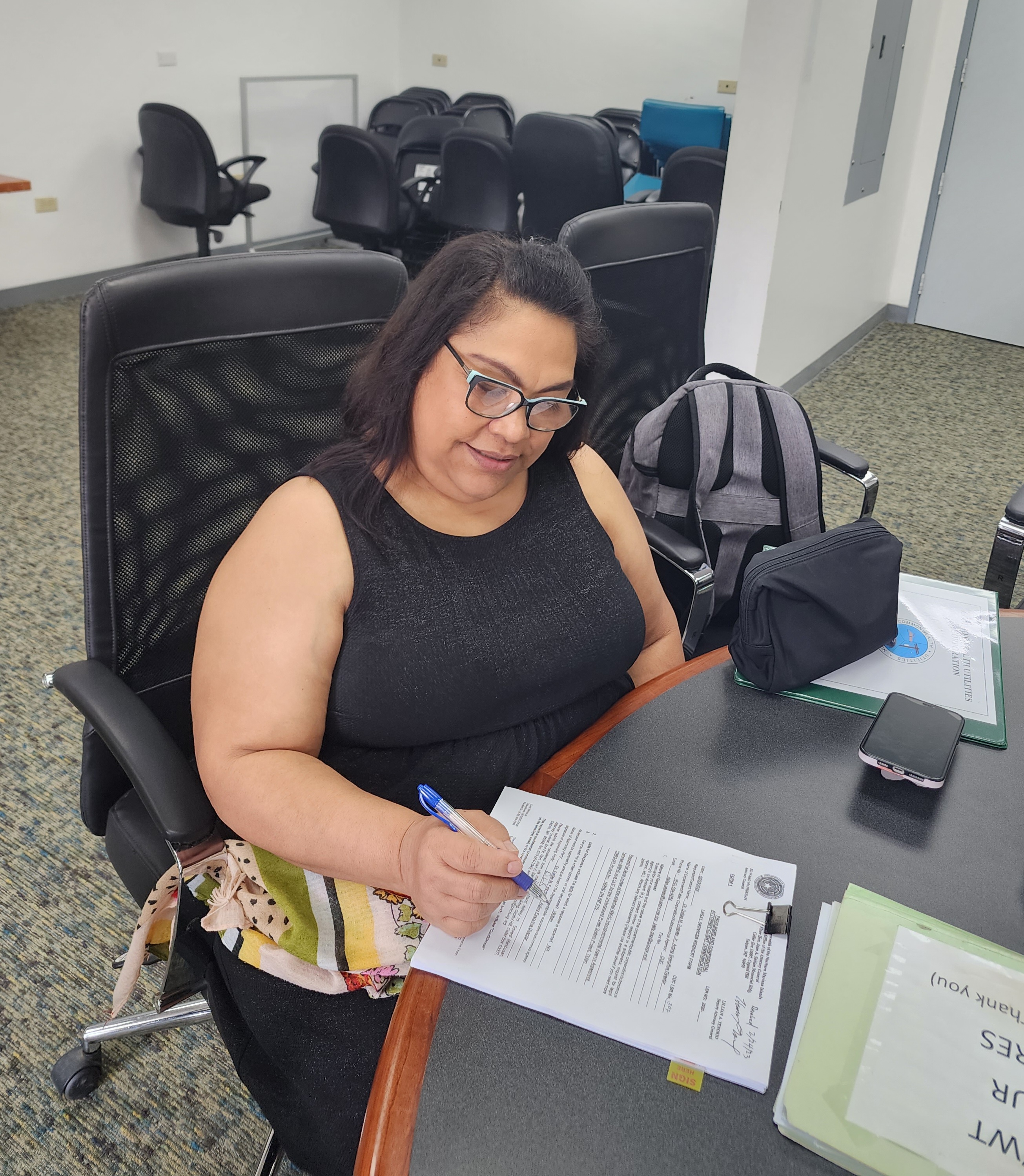 Commonwealth Utilities Corp. Board Chairwoman Janice Tenorio signs a document after a meeting on Friday.