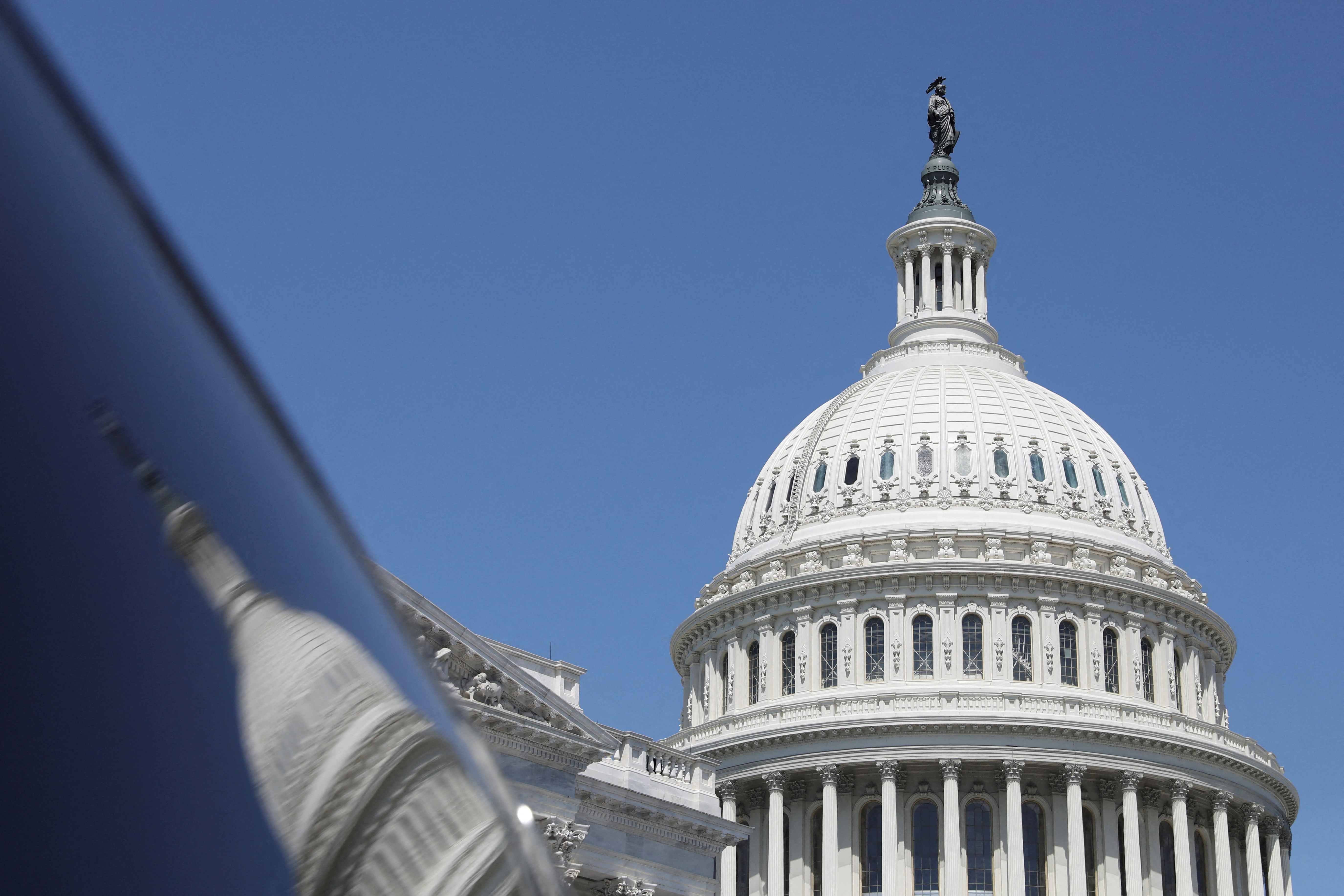 The dome of the U.S. Capitol is reflected in a window on Capitol Hill in Washington, U.S., April 20, 2023. REUTERS/Amanda Andrade-Rhoades/File Photo