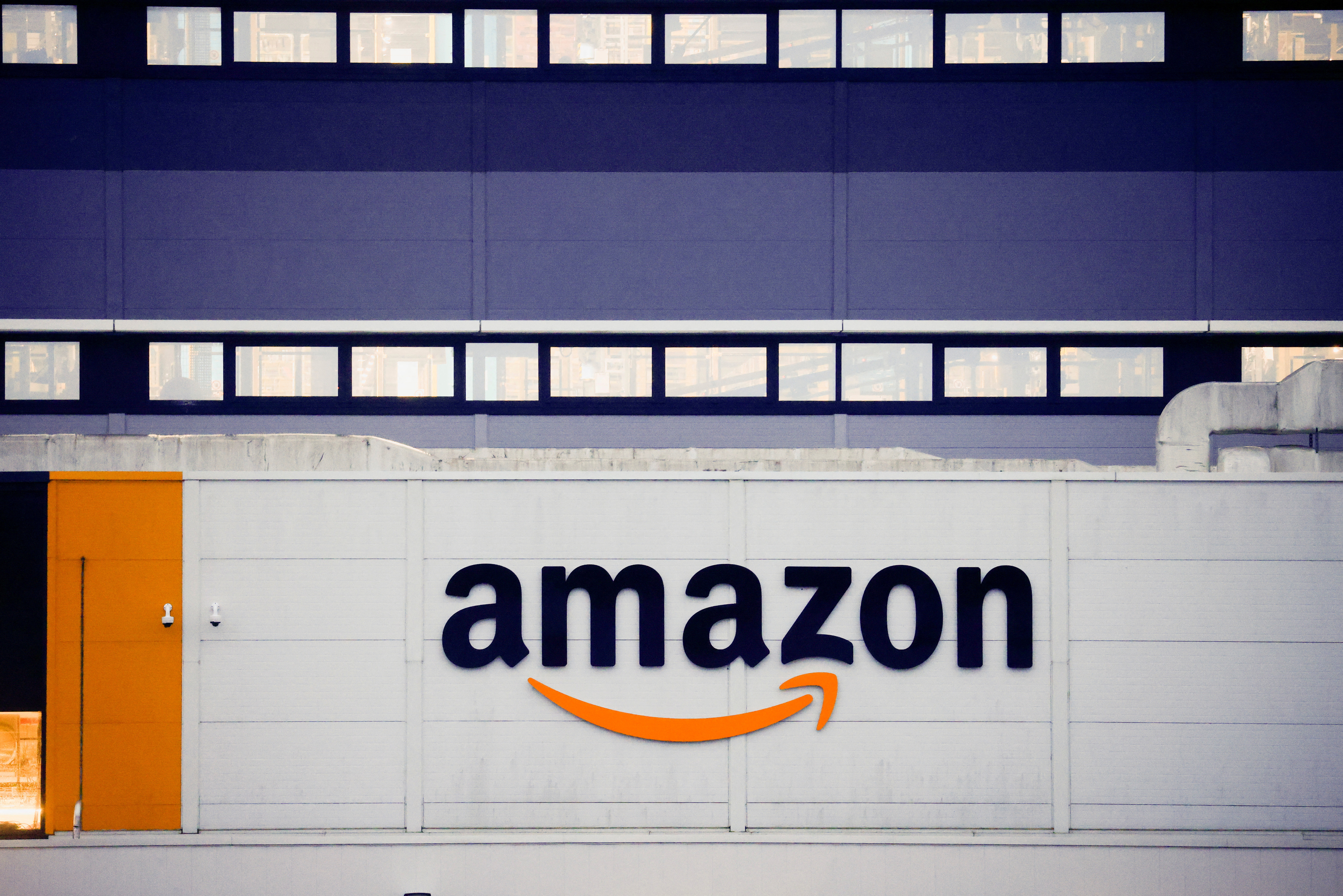 FILE PHOTO: The logo of Amazon is seen at the company's logistics center in Bretigny-sur-Orge, near Paris, France, December 7, 2021. REUTERS/Gonzalo Fuentes/File Photo