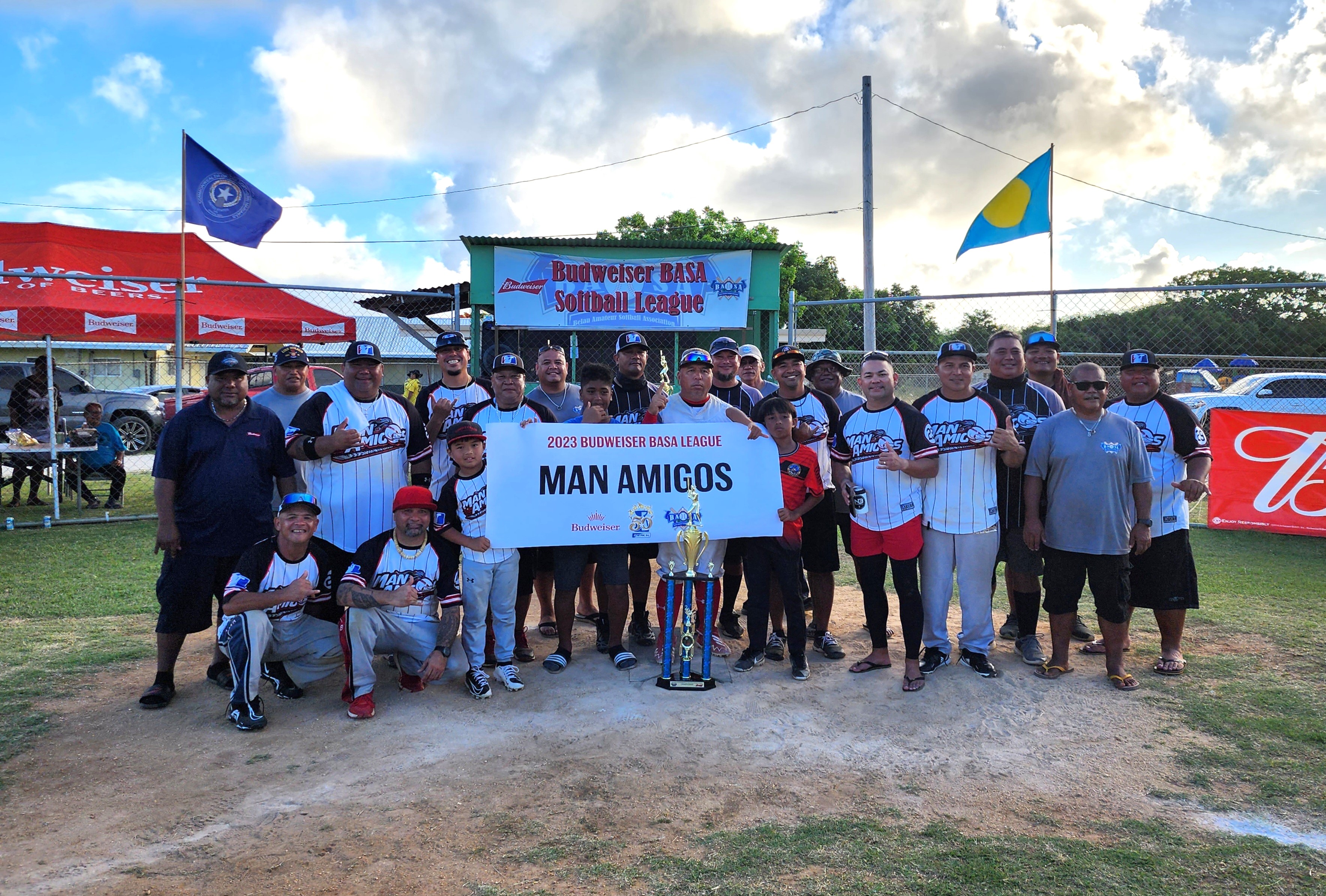 The Man Amigos pose with the 2023 Budweiser Belau Amateur Softball Association Softball League  trophy after defeating Peleliu in a best-of-three series on Sunday at the Dandan baseball field.