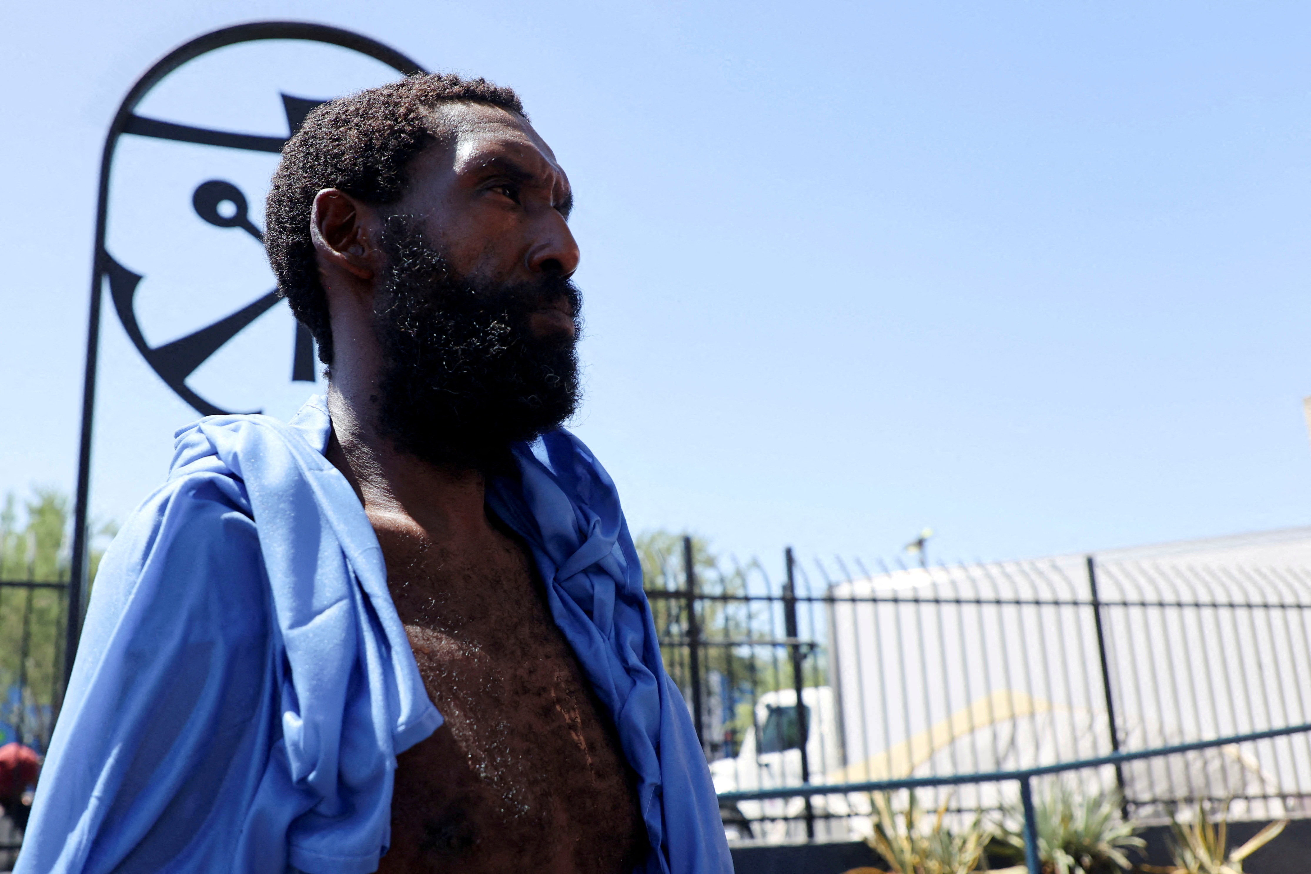 Unhoused people at a downtown Phoenix homeless encampment receive medical care from Circle The City's mobile medical unit on the 14th day of temperatures rising to 110 degrees Fahrenheit, in Phoenix, Arizona, U.S., July 13, 2023. REUTERS/Liliana Salgado/