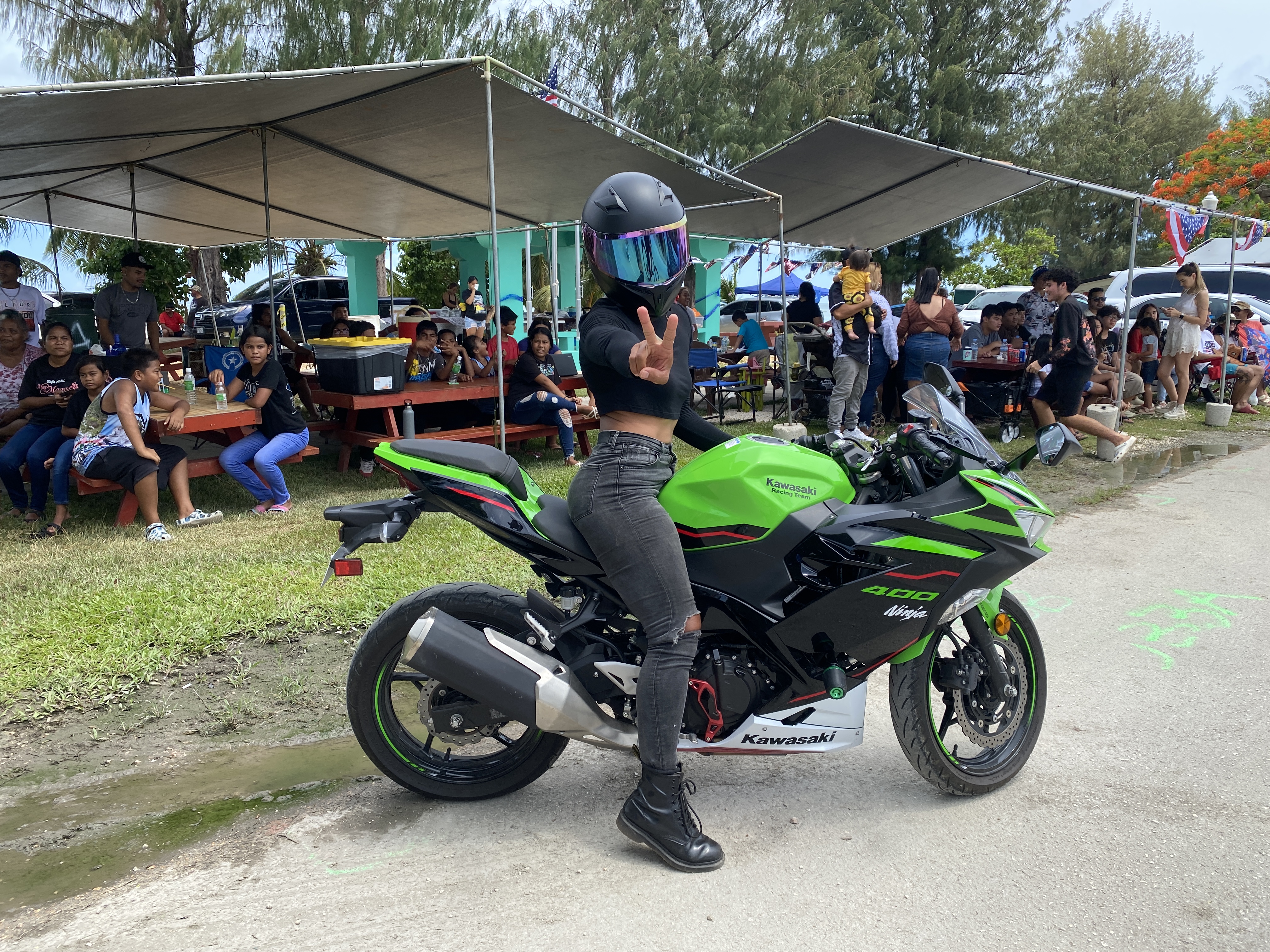A motorcyclist poses for a photo before joining the parade.