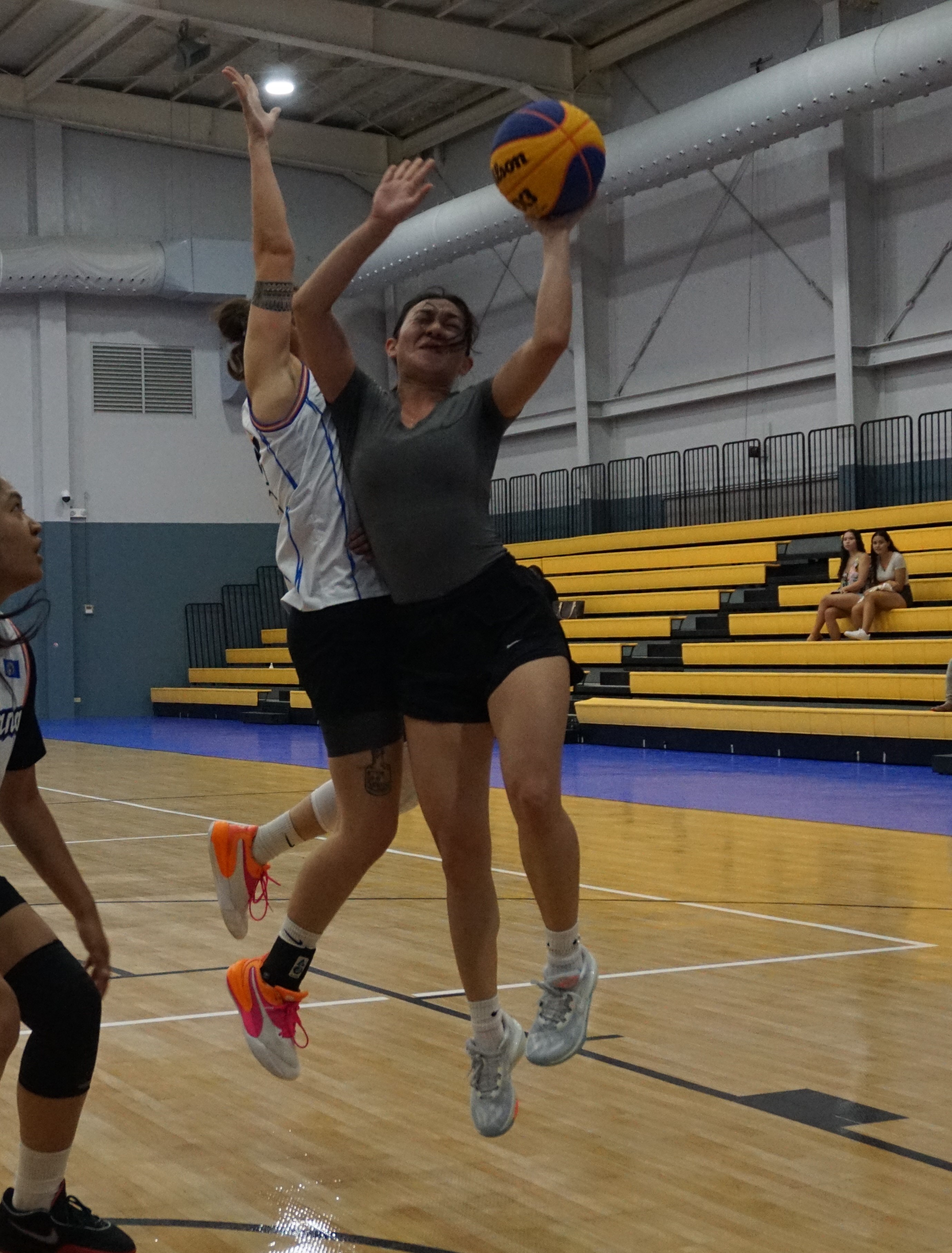 4 Locals' Quina Flores protects the ball as she goes up for the shot against Shots Fired's Michelle Kautz during the women’s division 3x3 championship game of the 2023 NMI-Pohnpei Goodwill Basketball Games on Friday at the Ada gym.