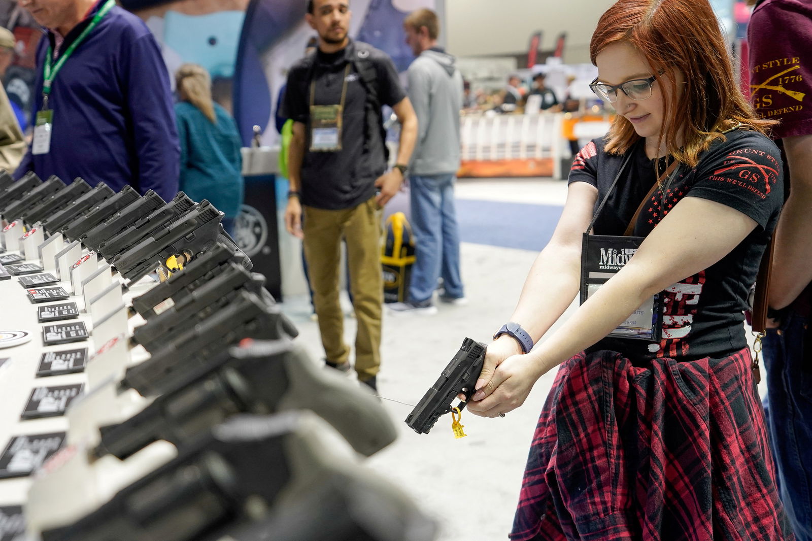 A woman holds a Smith and Wesson handgun at the National Rifle Association's (NRA) annual meeting, in Indianapolis, Indiana, U.S., April 28, 2019. REUTERS/Bryan Woolston/File Photo
