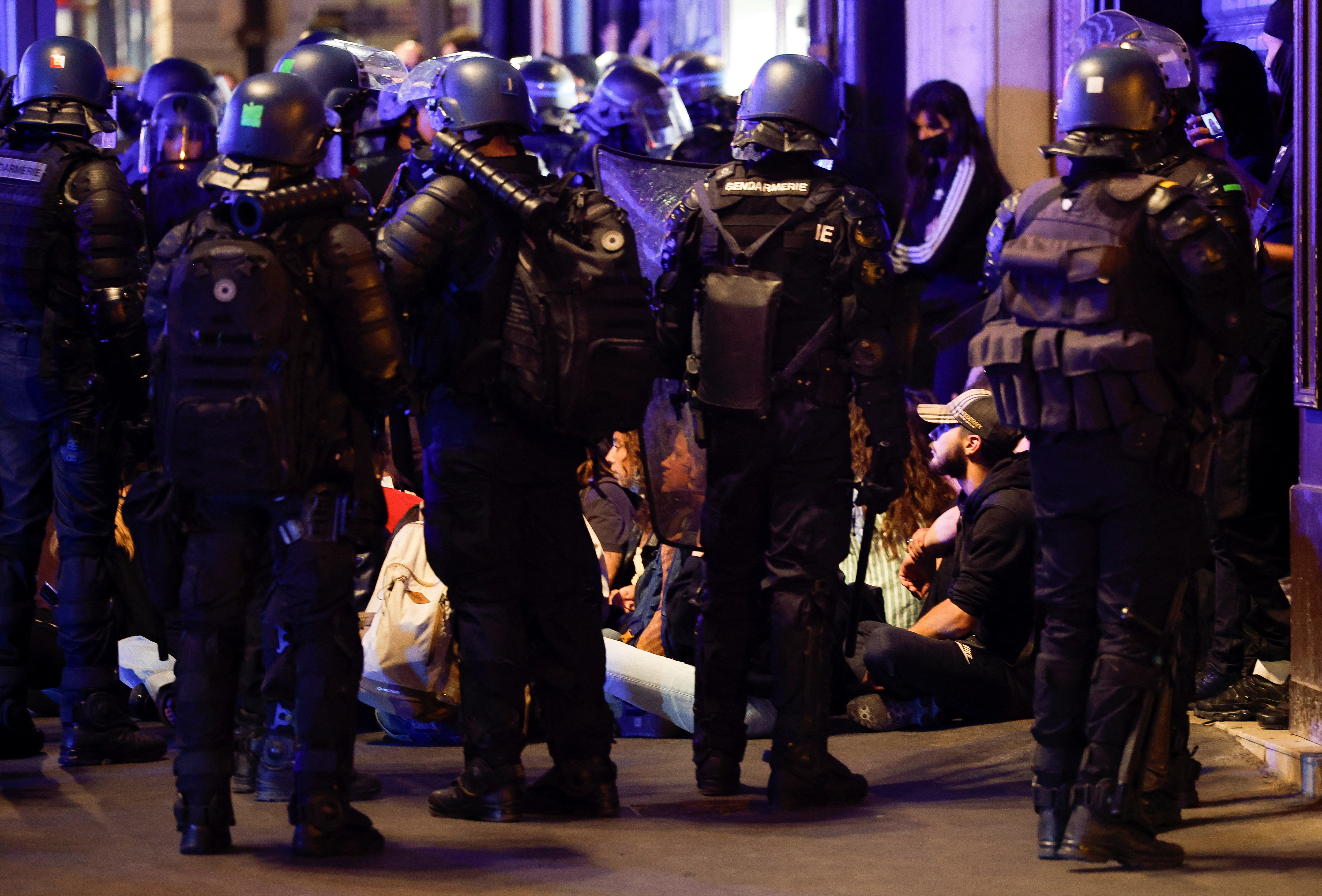 Police officers stand guard as people protest near Opera Garnier, following the death of Nahel, a 17-year-old teenager killed by a French police officer in Nanterre during a traffic stop, and against police violence, in Paris, France, June 30, 2023. REUTERS/Juan Medina