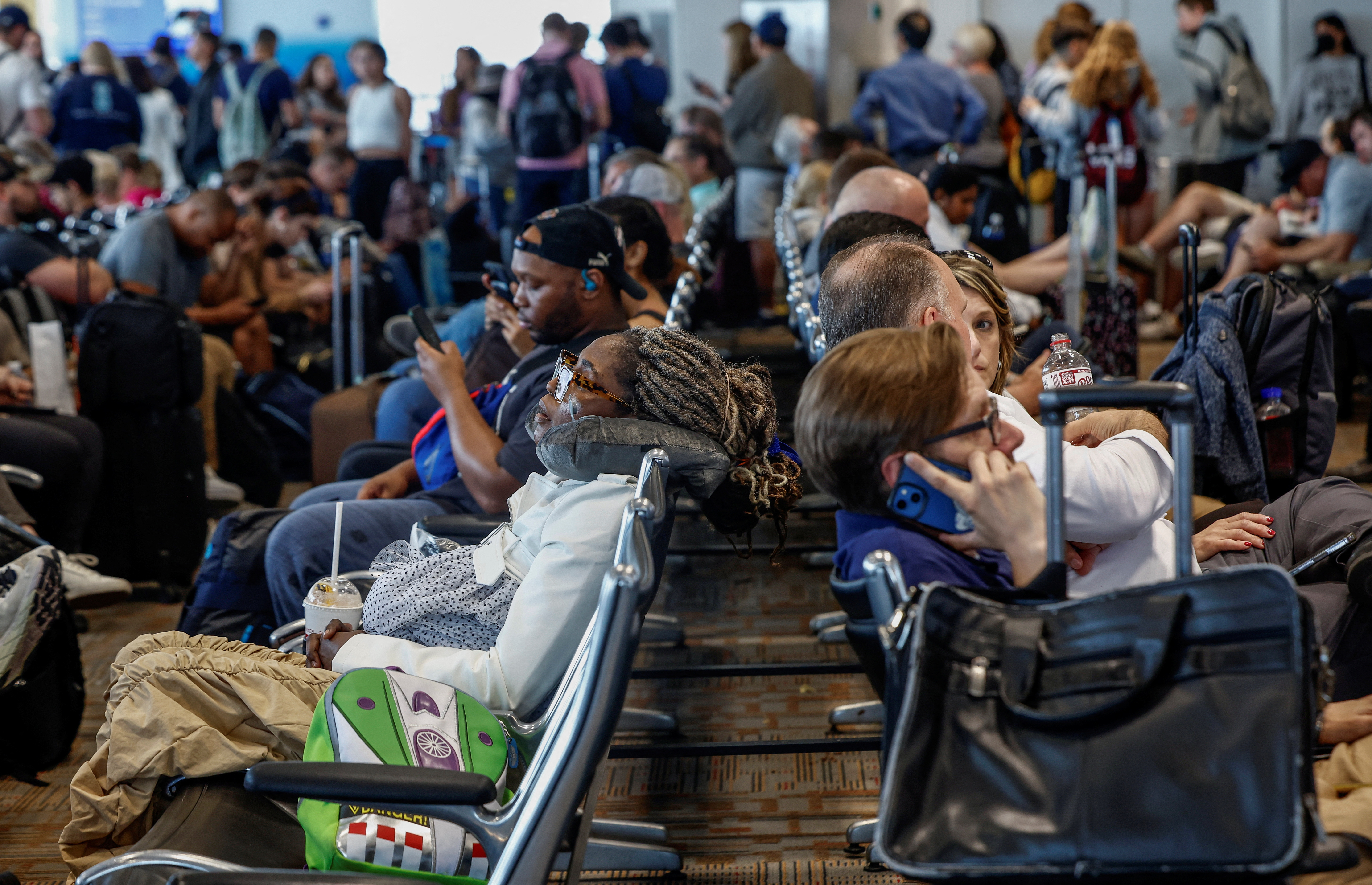 Delayed travelers wait for air traffic to resume at Ronald Reagan Washington National Airport ahead of the July 4th holiday weekend in Arlington, Virginia, U.S., June 30, 2023. REUTERS/Evelyn Hockstein