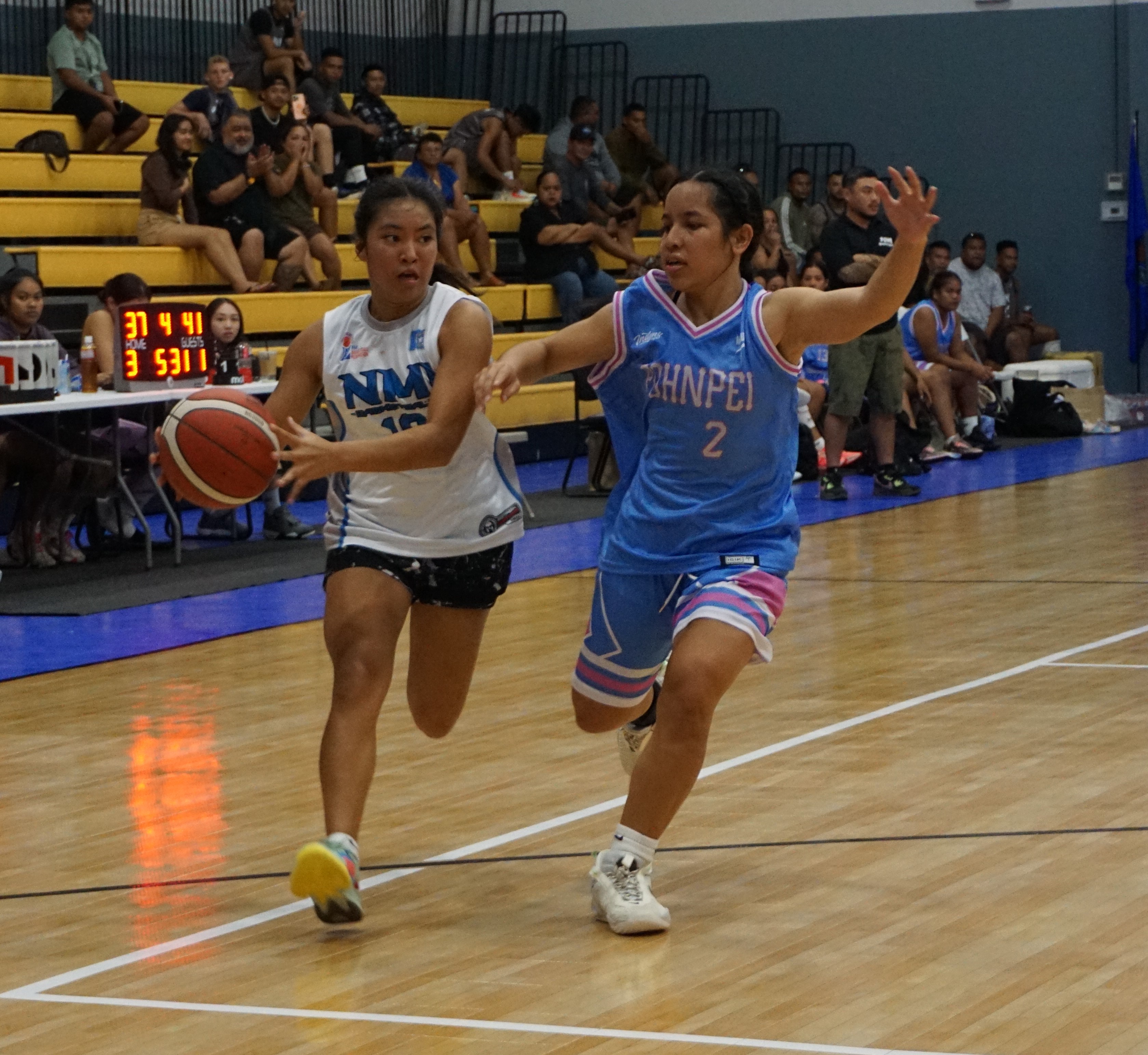 Junior Marianas' Yasmeen Younis protects the ball as Pohnpei's Vanessa Helgenberger closes in during a goodwill game Tuesday at the Ada gym.