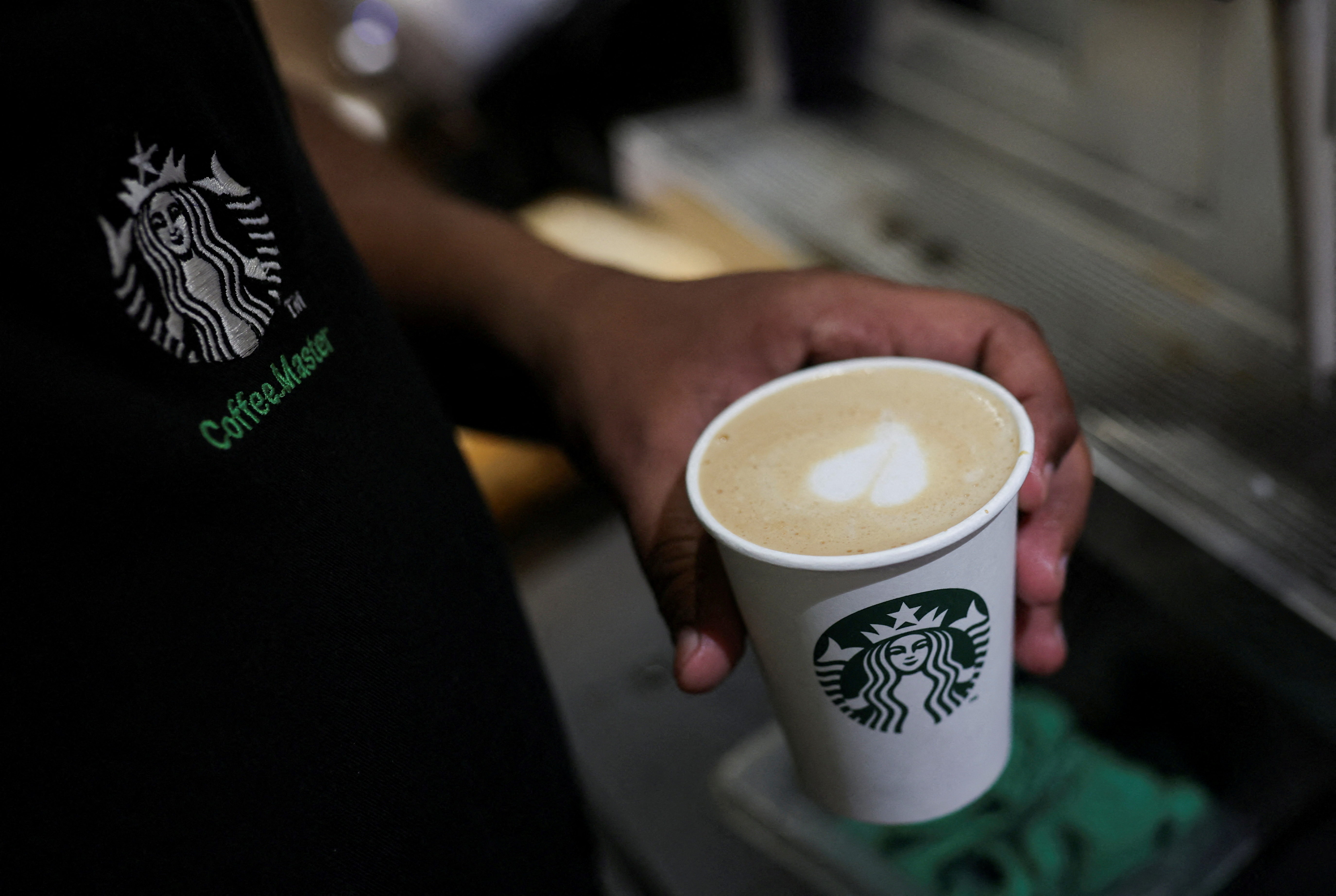 An employee prepares a coffee drink at a Starbucks' outlet at a market in New Delhi, India, May 30, 2023. REUTERS/Anushree Fadnavis/File Photo