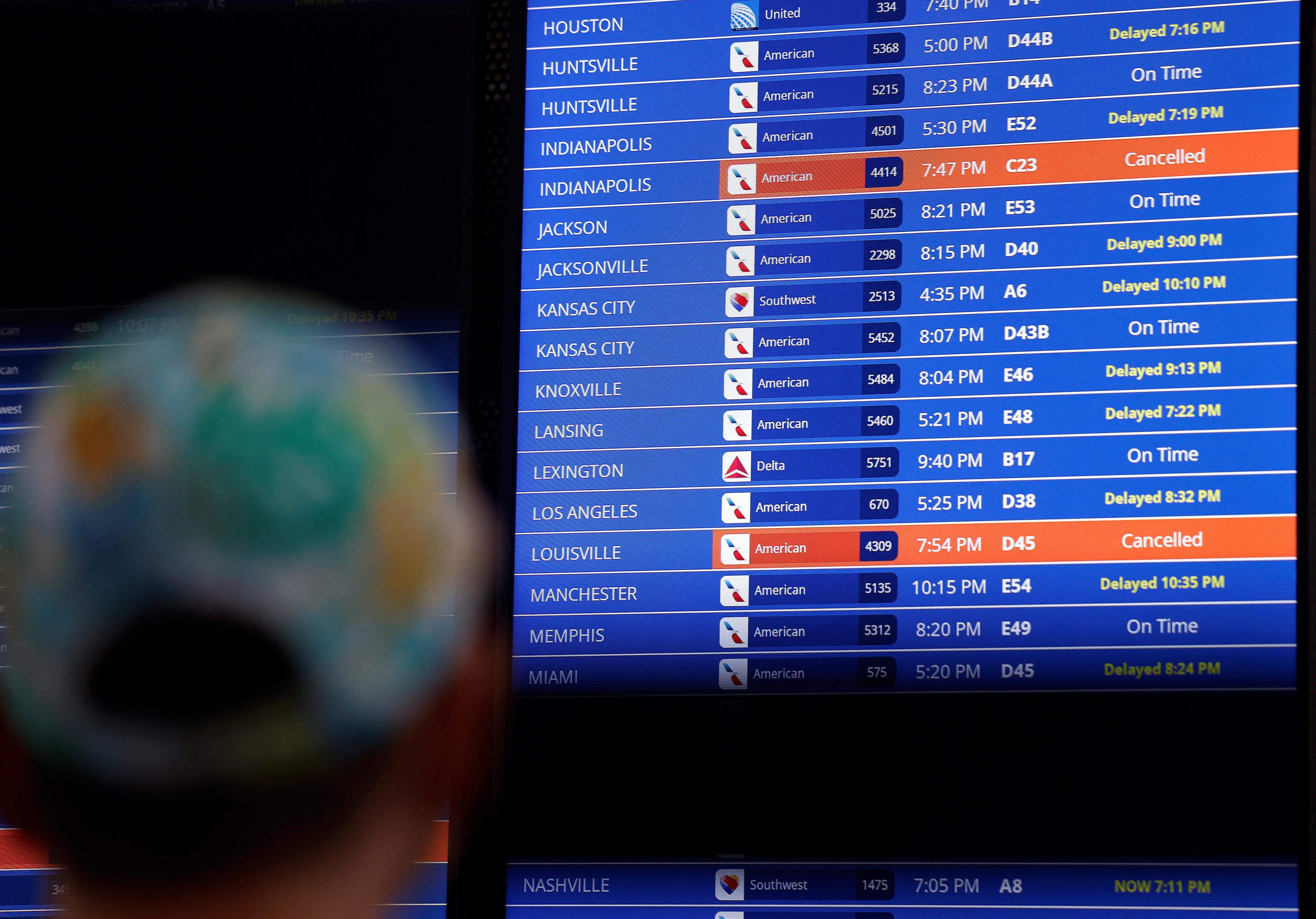 Travelers check the status of their flights ahead of the July 4th holiday weekend at Ronald Reagan Washington National Airport in Arlington, Virginia, U.S., June 30, 2023. REUTERS/Evelyn Hockstein