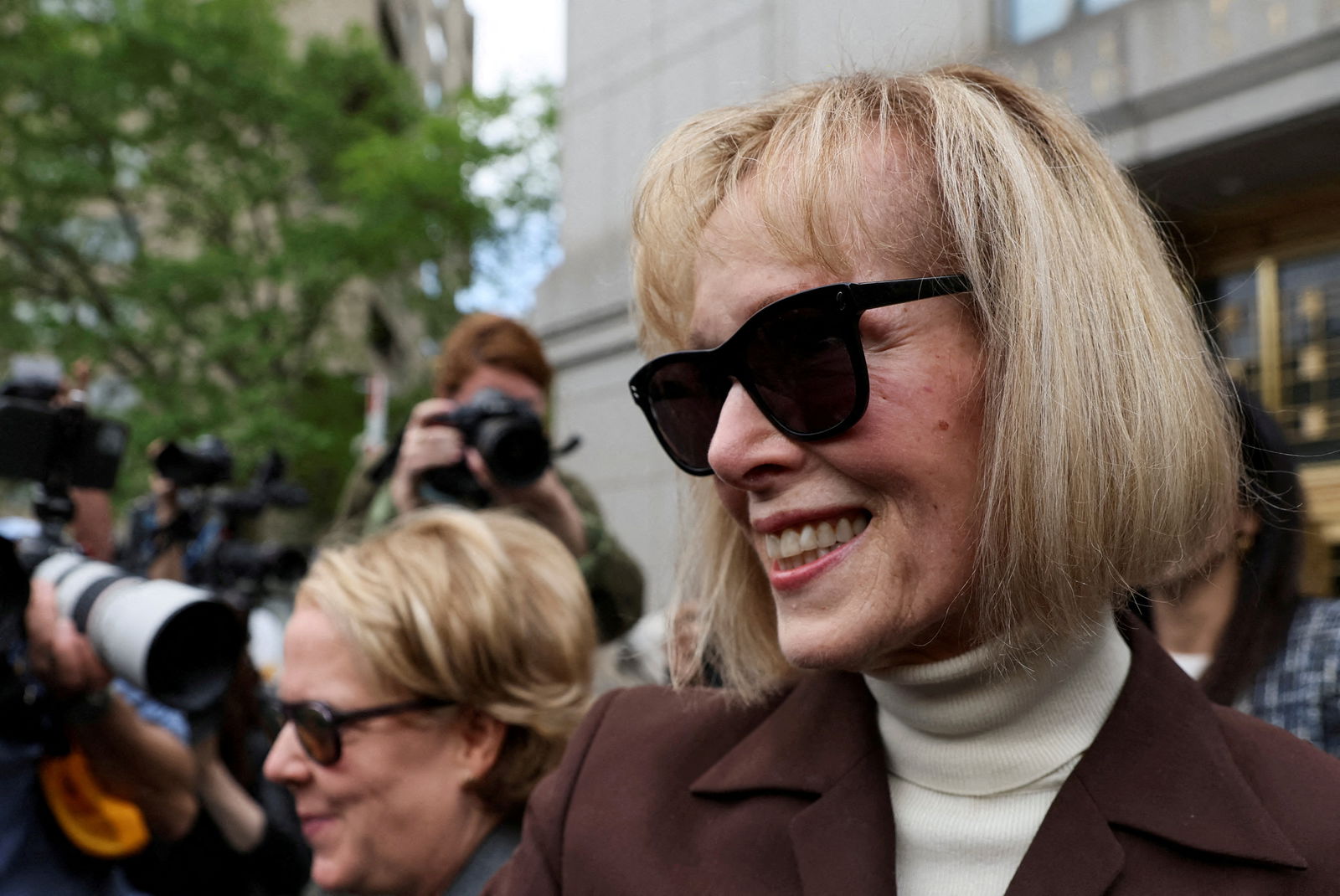 E. Jean Carroll reacts as she exits the Manhattan Federal Court following the verdict in the civil rape accusation case against former U.S. President Donald Trump, in New York City, U.S., May 9, 2023. REUTERS/Brendan McDermid/File Photo