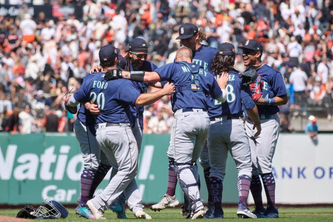 Seattle Mariners dance on the field in a circle to celebrate a win against the San Francisco Giants after the final out ninth inning at Oracle Park in San Francisco, California, July 4, 2023.