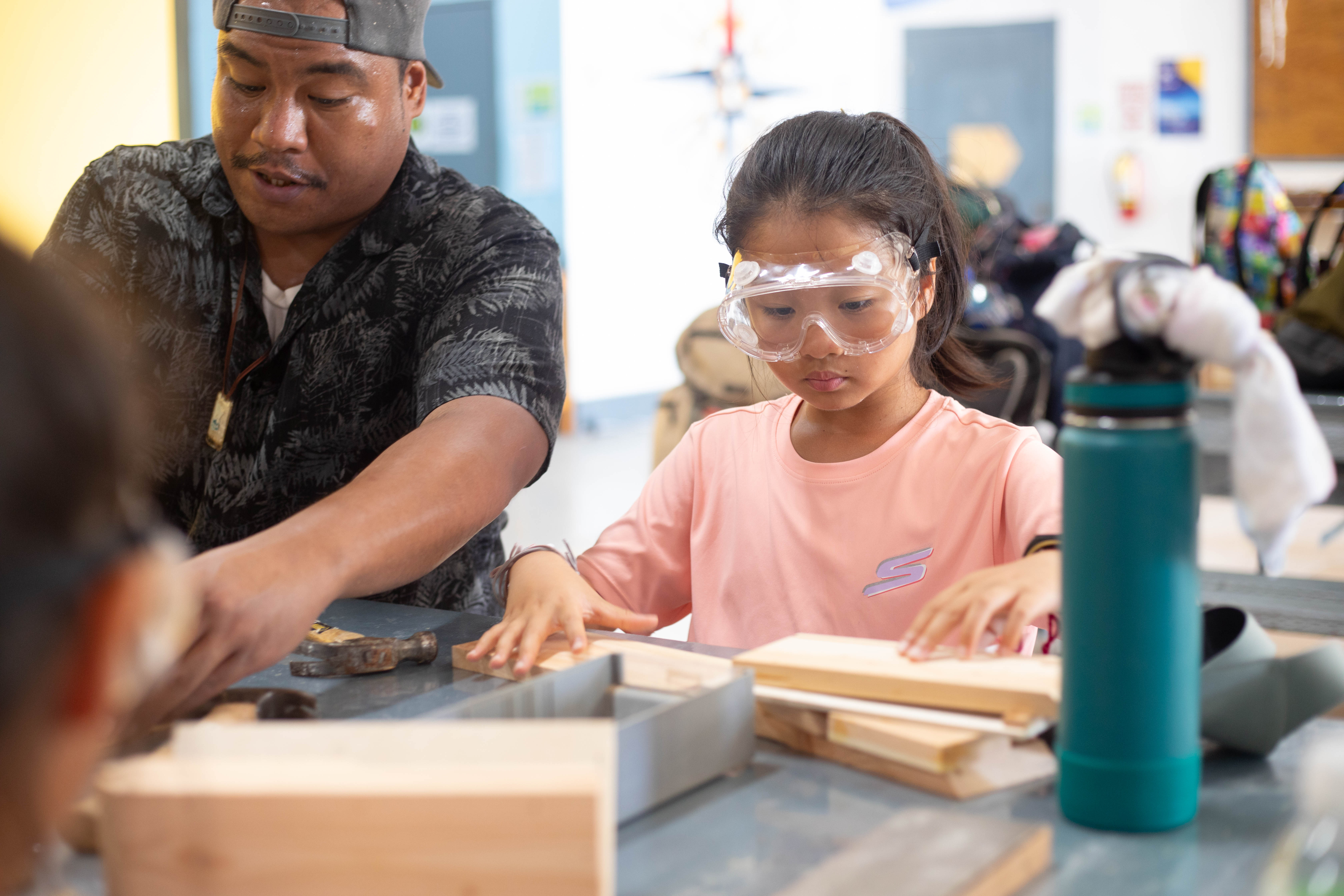 One of the junior campers from 4-H Marianas' Camp Maga'lahi practices her woodworking skills with an instructor from the Northern Marianas Technical Institute.