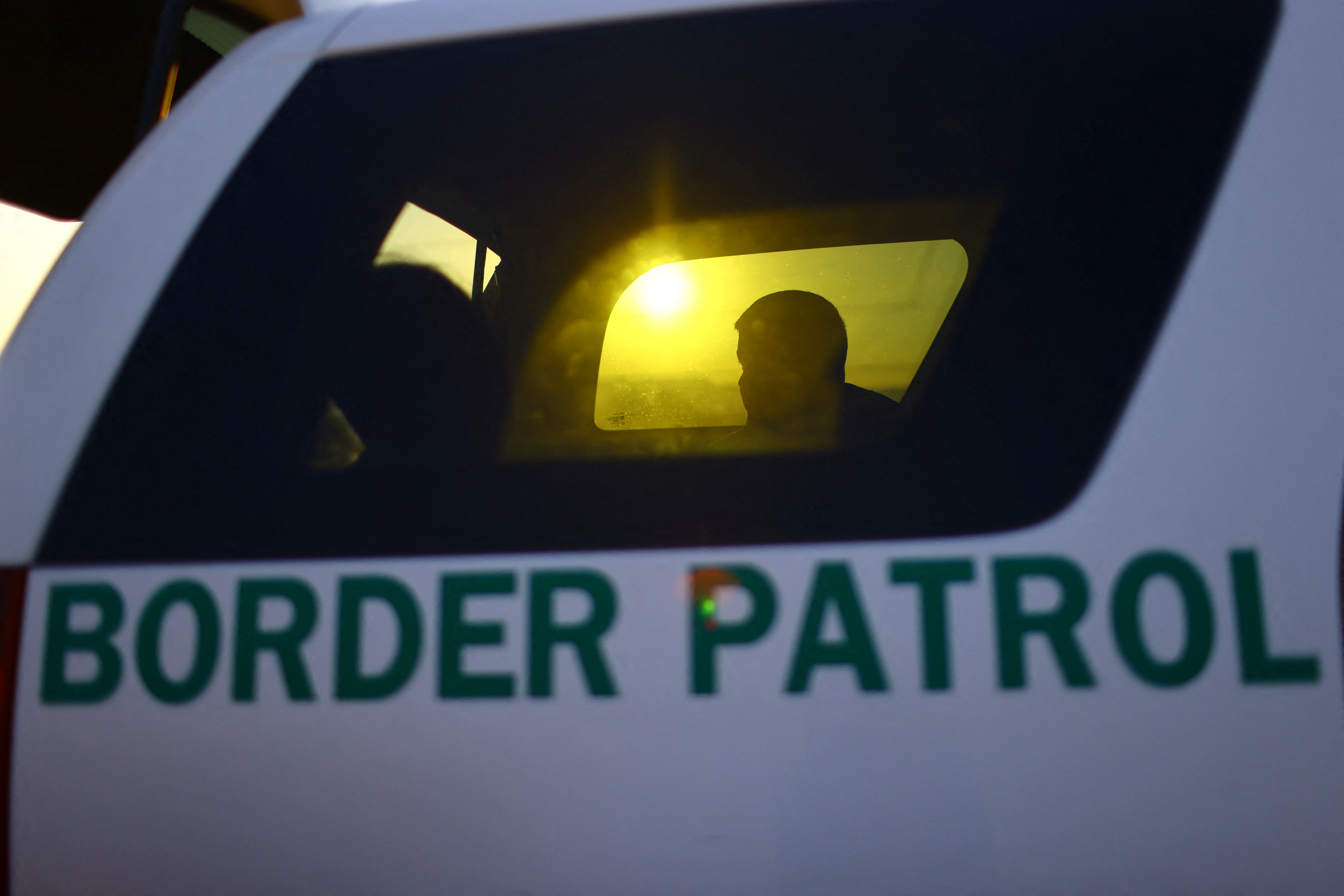 A migrant sits in a Border Patrol vehicle after being apprehended crossing the U.S.-Mexico border in the desert of Sunland Park, New Mexico, U.S. June 23, 2023. REUTERS/Jose Luis Gonzalez