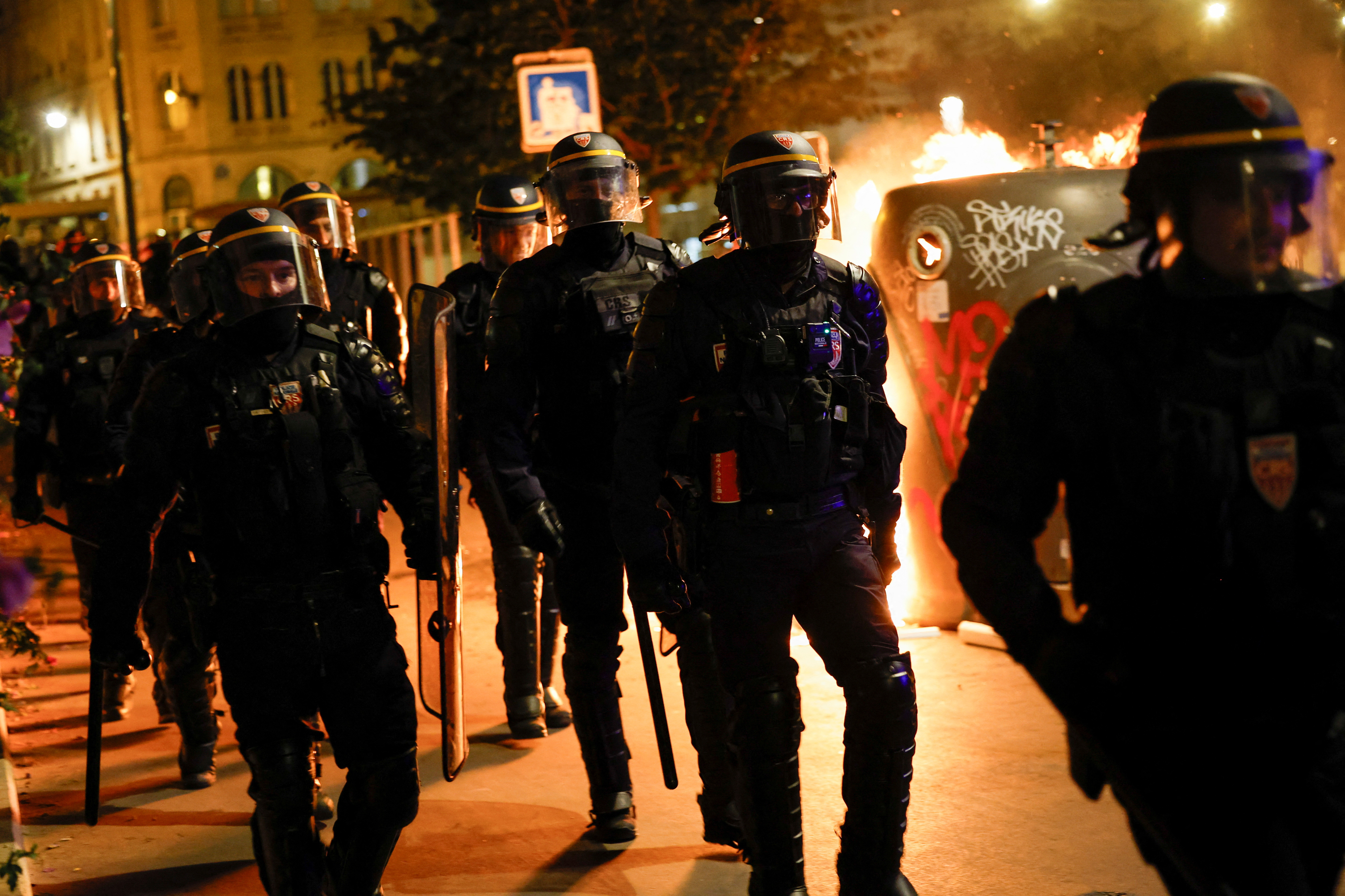 A group of police officers walk as people protest following the death of Nahel, a 17-year-old teenager killed by a French police officer in Nanterre during a traffic stop, and against police violence, in Paris, France, June 30, 2023. REUTERS/Juan Medina