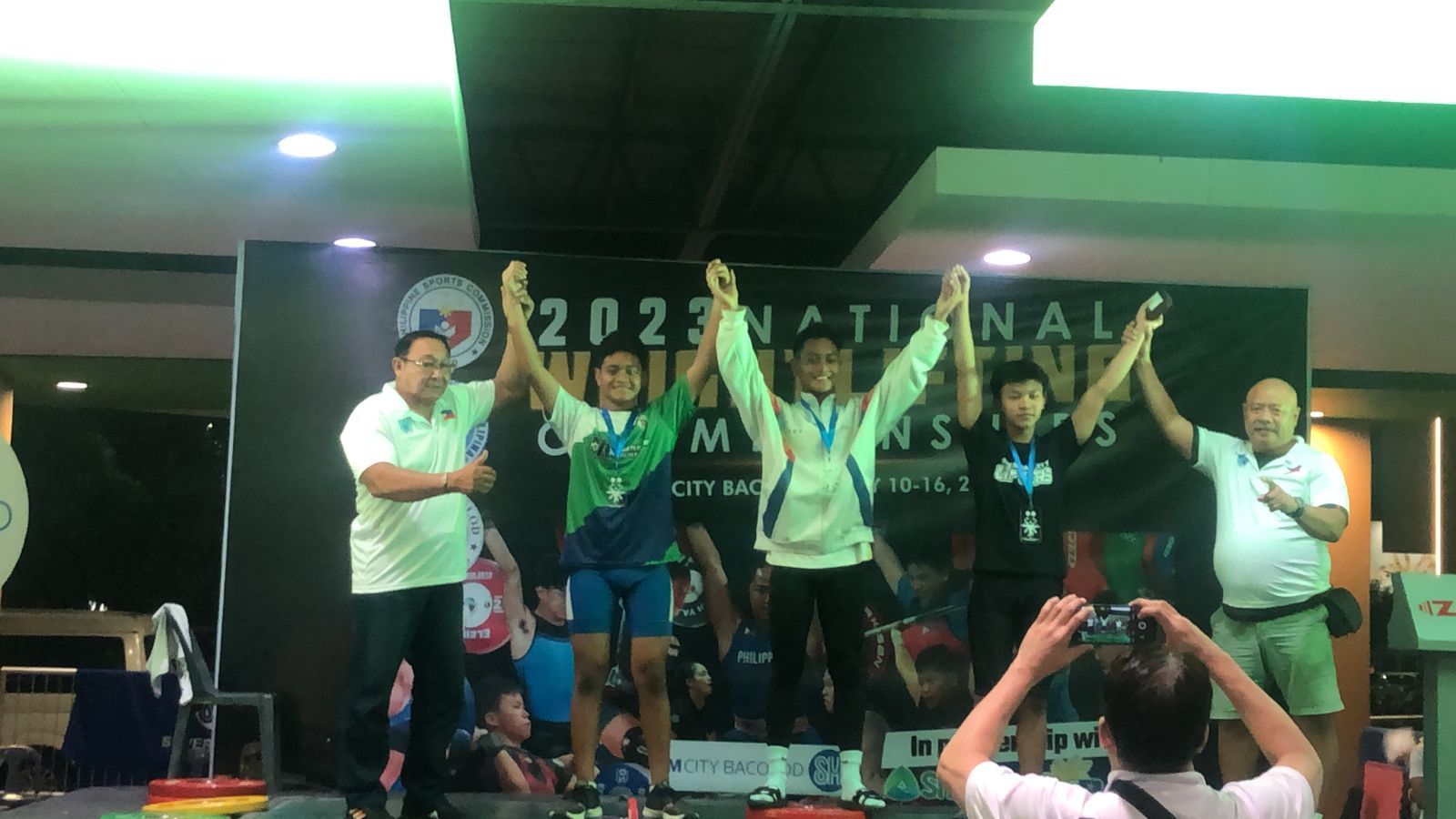 Jaden Andrew, 2nd left, poses with the silver medal during the awards ceremony of the Philippine National Weightlifting Championship in Bacolod, in the central Philippines on Saturday.