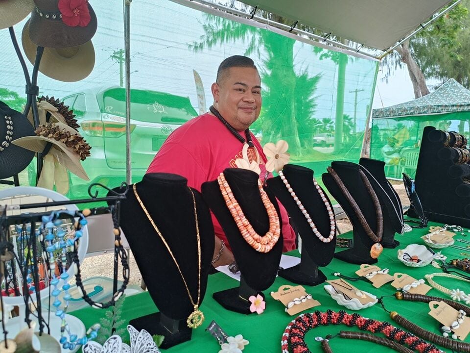 Norman Rasiang showcases an array of traditional jewelry and crafts at his vendor stall.