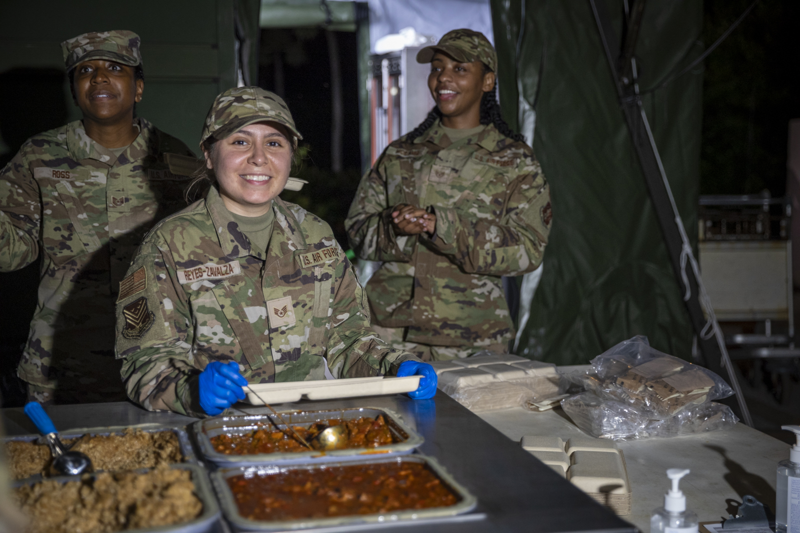 U.S. Air Force Staff Sgt. Giselle Reyes-Zivalza, 116th Food Support Squadron, serves service members dinner at Innovative Readiness Training Operation Wellness CNMI on Saipan, Northern Mariana Islands, on July 11, 2023.