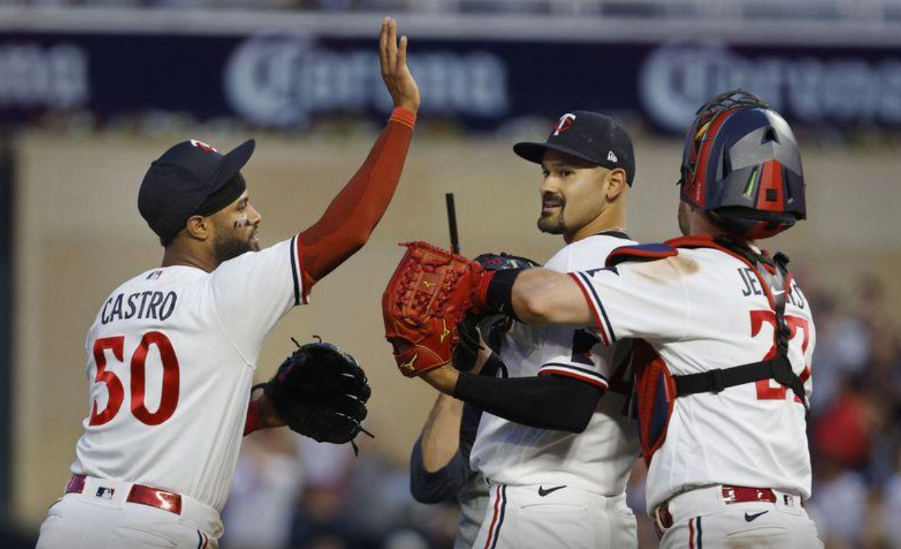 Minnesota Twins starting pitcher Pablo Lopez (49) celebrates his shutout win over the Kansas City Royals with catcher Ryan Jeffers (27) and center fielder Willi Castro (50) after the ninth inning at Target Field in Minneapolis, Minnesota, July 5, 2023.