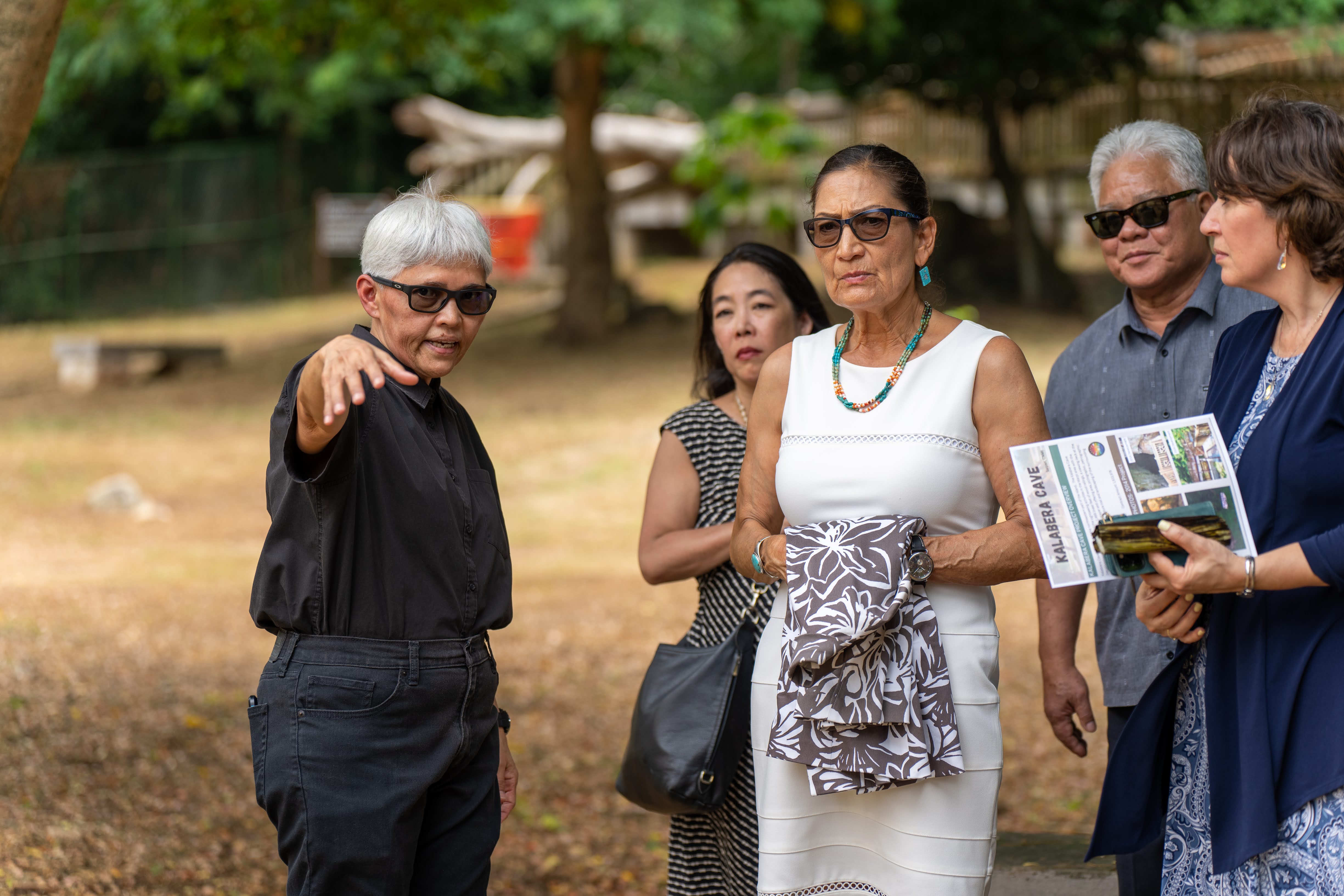 CNMI cultural historian Genevieve Cabrera, left, explains the history and significance of Kalabera Cave to U.S. Department of the Interior Secretary Deb Haaland, center, Assistant Secretary for Insular and International Affairs Carmen Cantor, right, and Deputy Assistant to the President & Asian American and Native Hawaiian and Pacific Islander Senior Liaison Erika Moritsugu, 2nd left, on Friday, July 21, 2023. Also in the photo: CNMI Gov. Arnold I. Palacios.