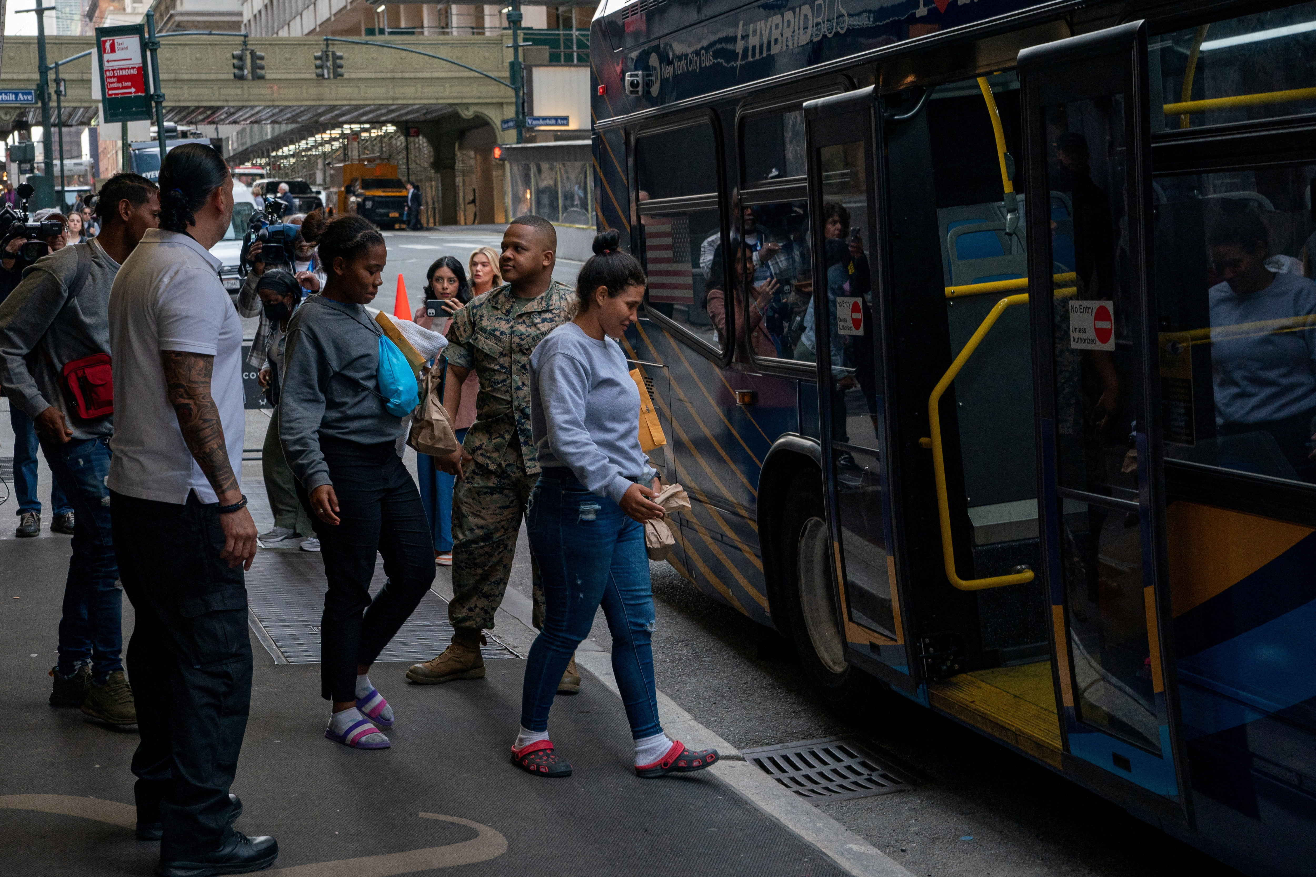 People exit the Roosevelt Hotel where asylum-seeker are currently being housed onto an M.T.A. bus in New York City, U.S., May 19, 2023. REUTERS/David 'Dee' Delgado/File Photo